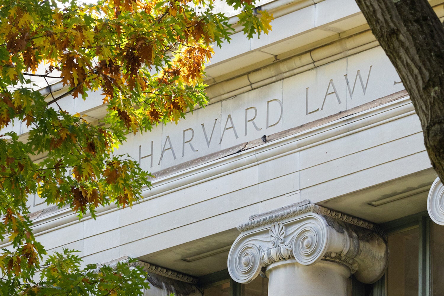 A detail of the facade of Langdell Hall in the fall.