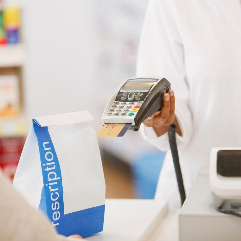 Person paying for a prescription.