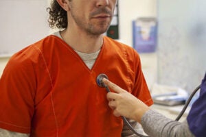 Man in prison uniform in a doctor's office