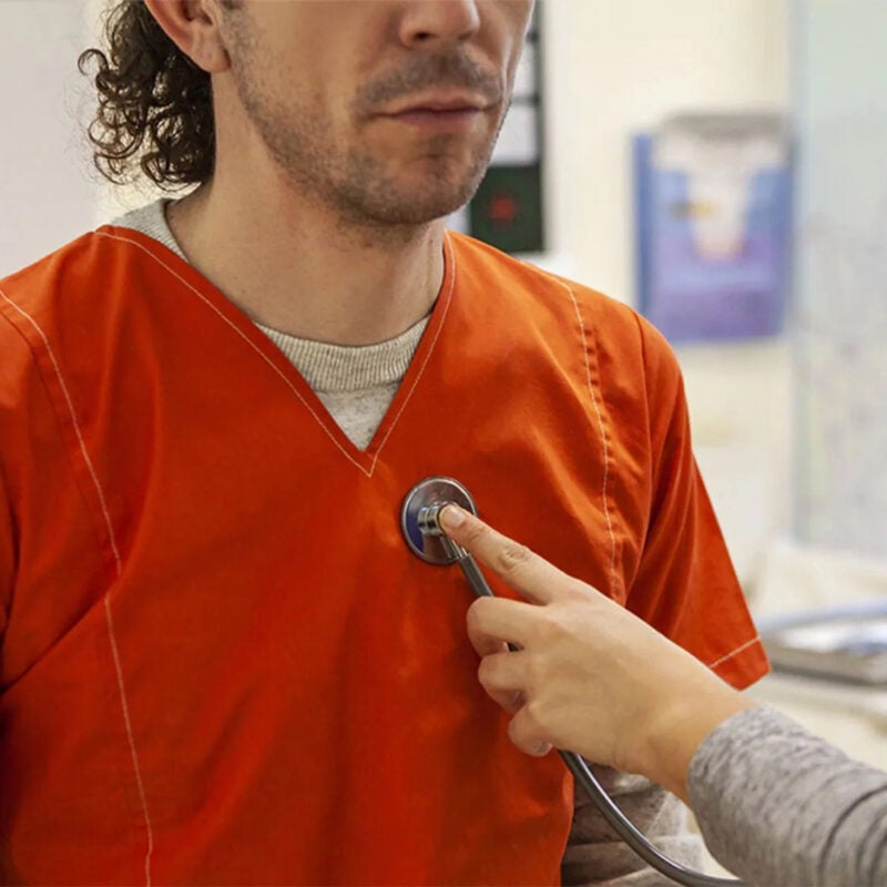 Man in prison uniform in a doctor's office