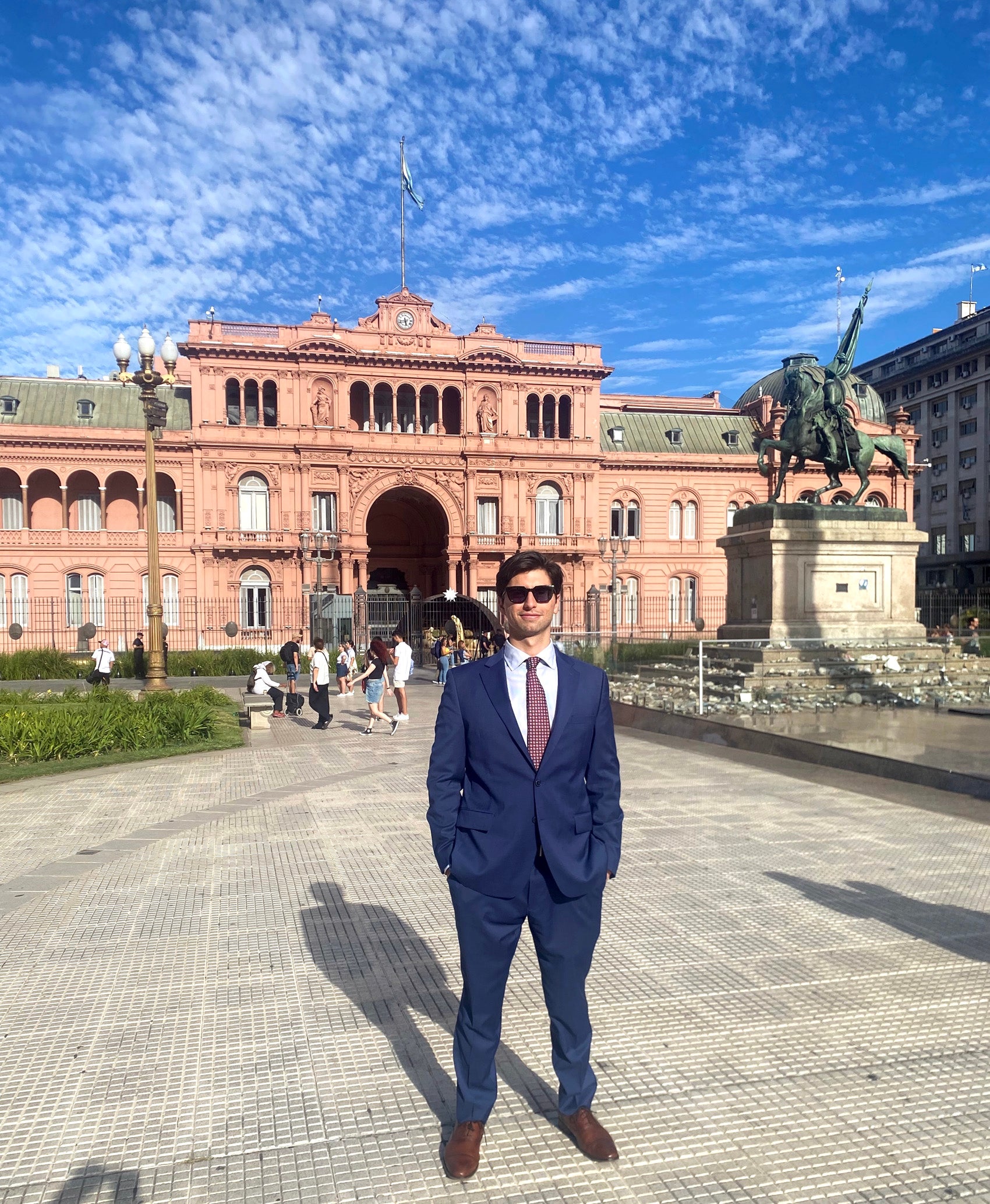 A man stands in a couryard outside a presidential palace
