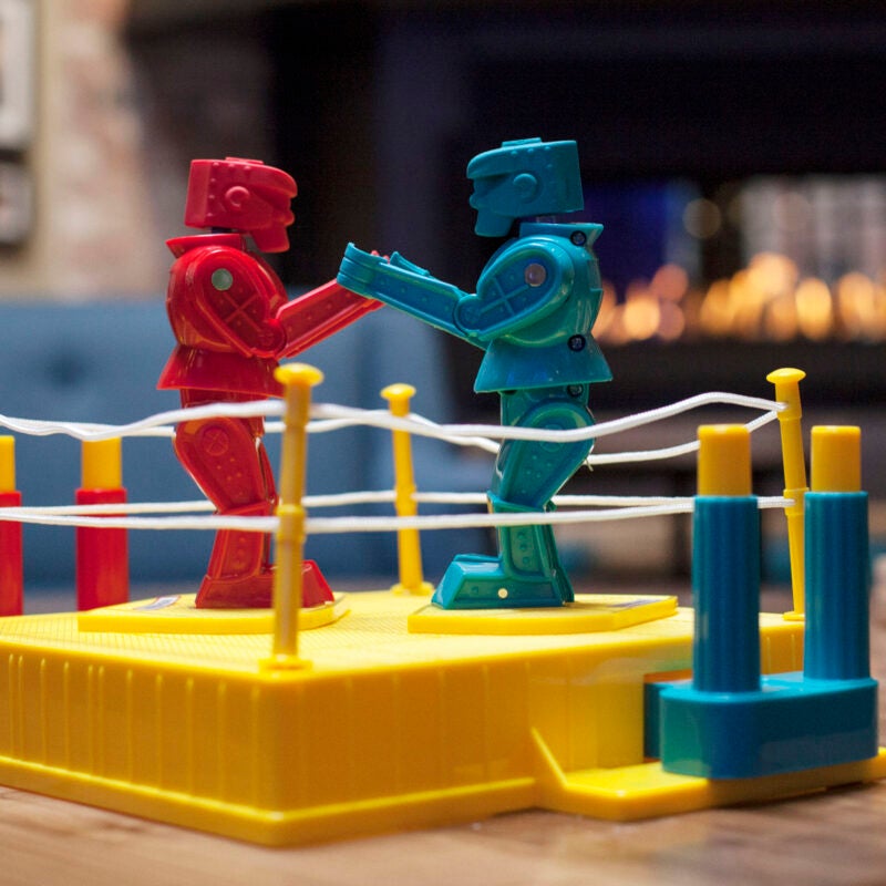 Toy robots fighting in a ring.