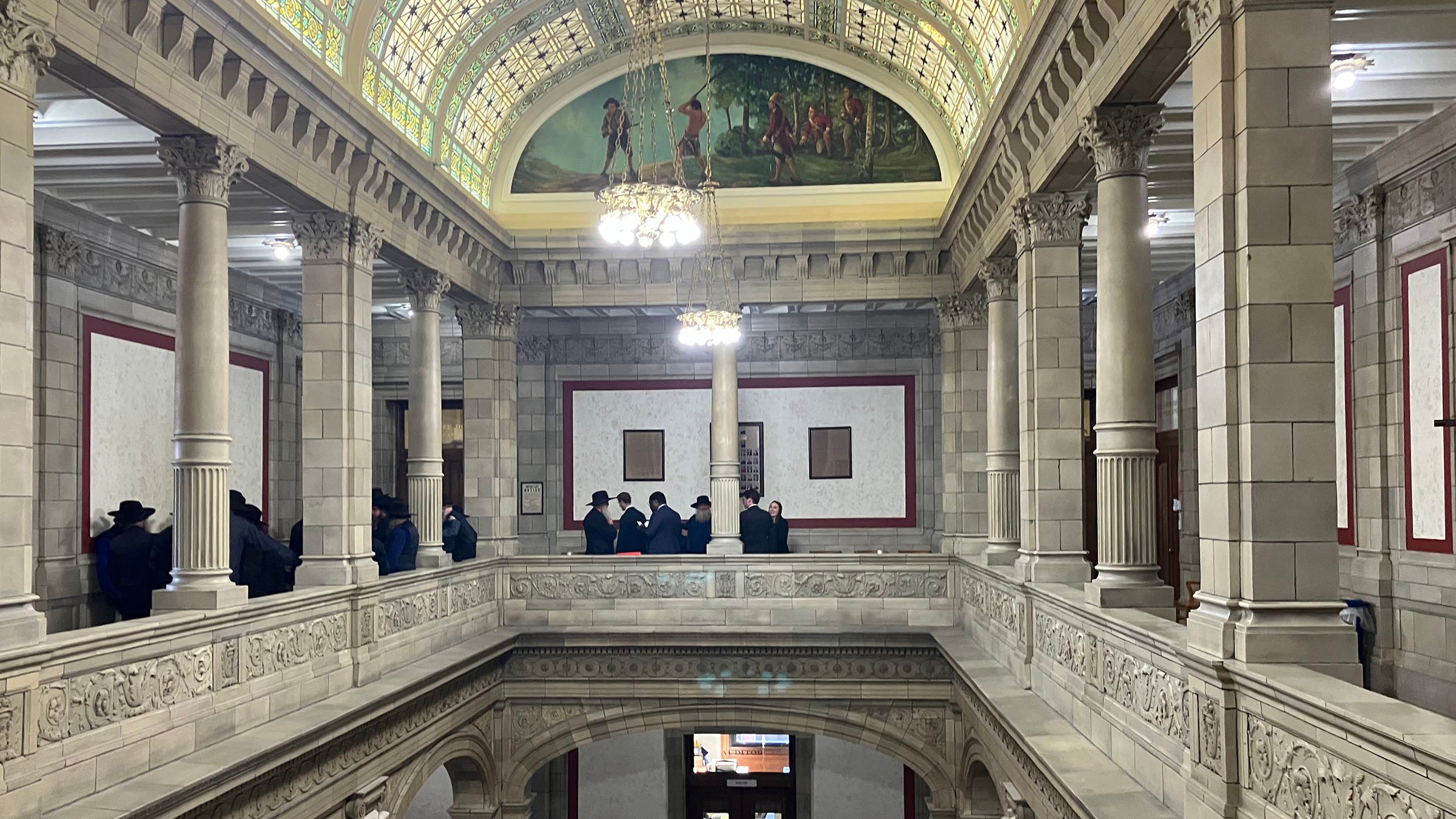 People gathered on the second level of a courthouse atrium.