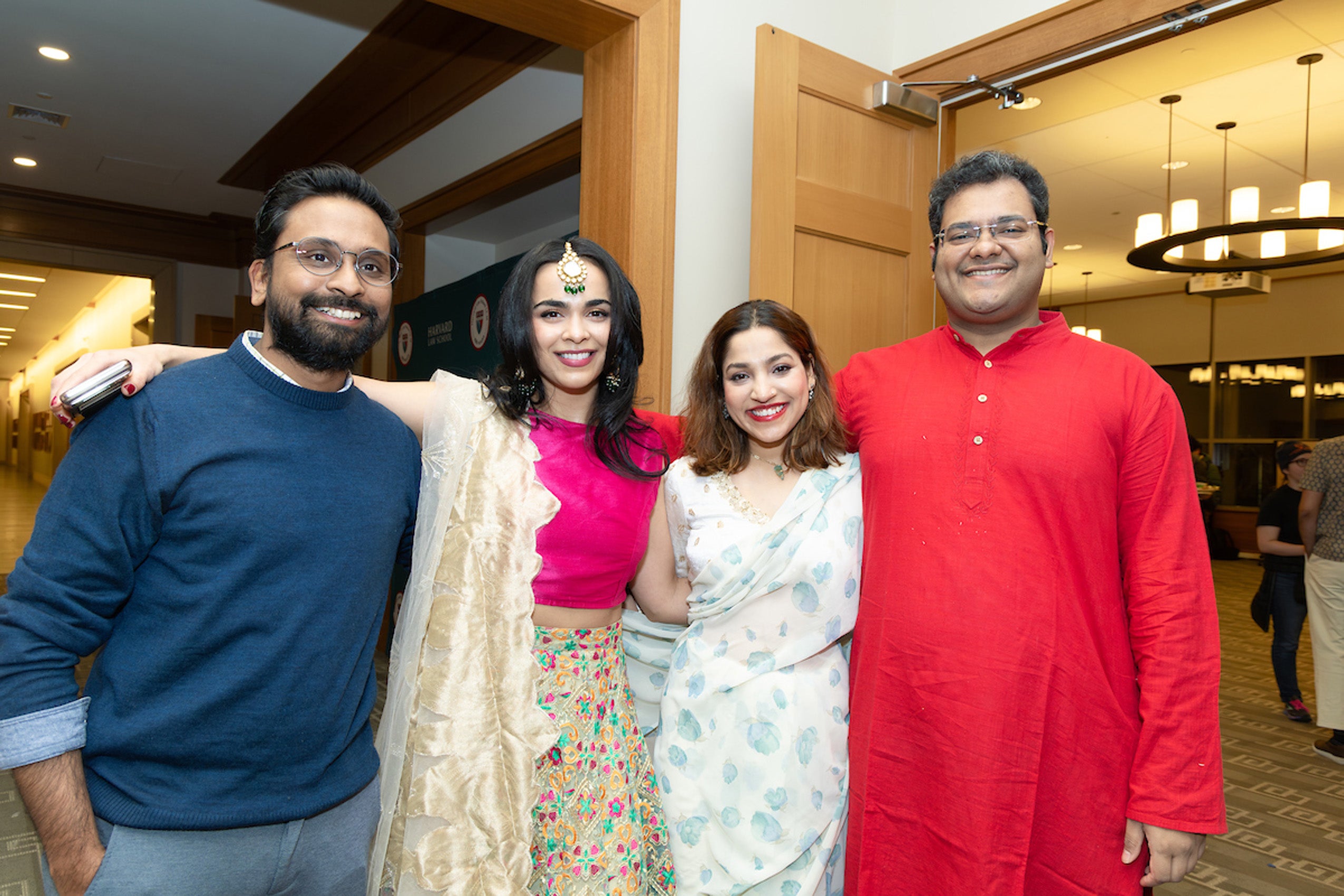 Students, some in the dress of their homeland pose for a photo at an event.