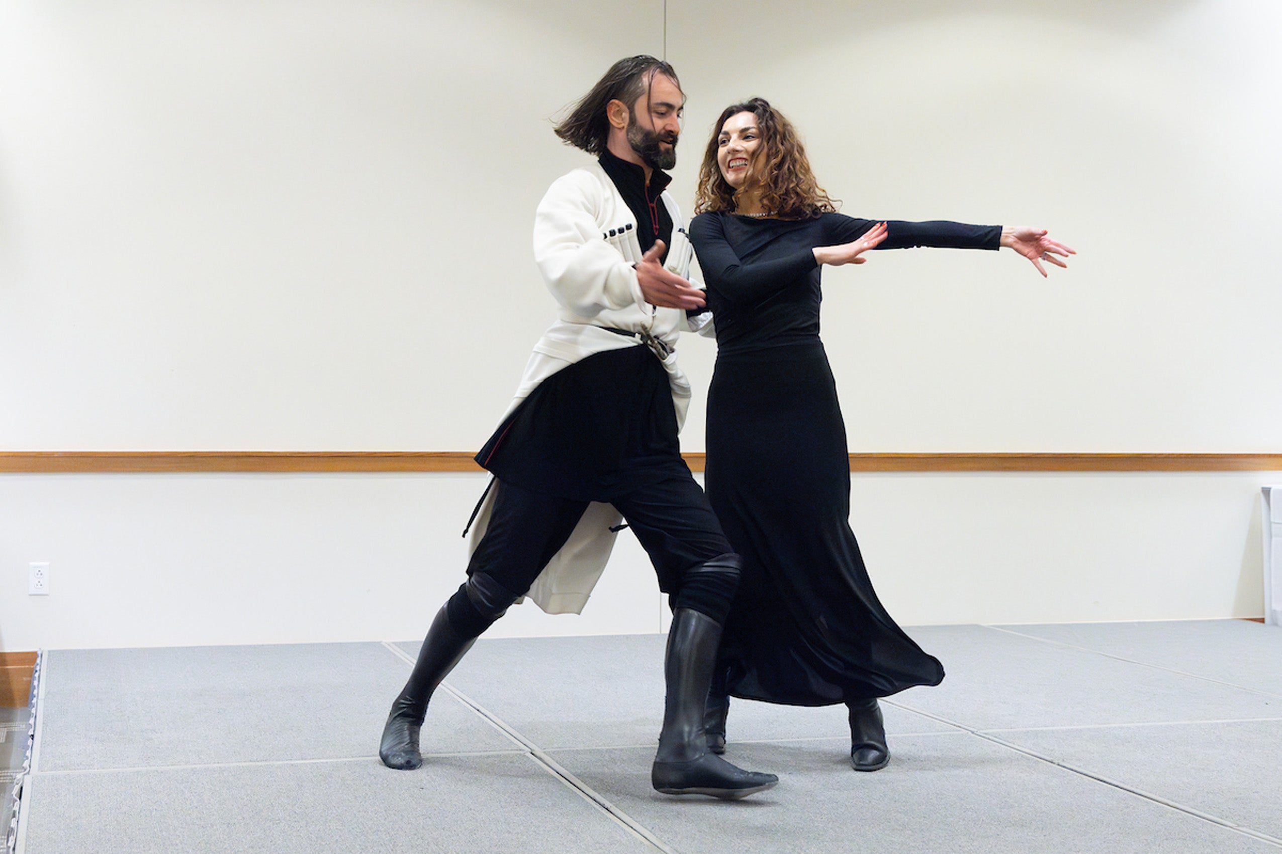 A man and a woman perform a dance on a stage.