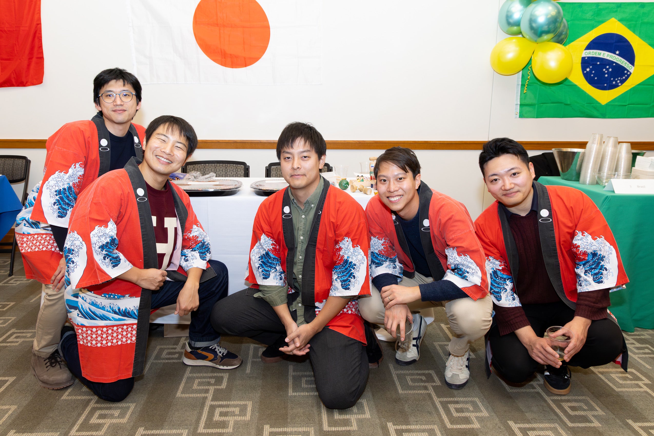 Students wearing traditional dress from their country post for photo