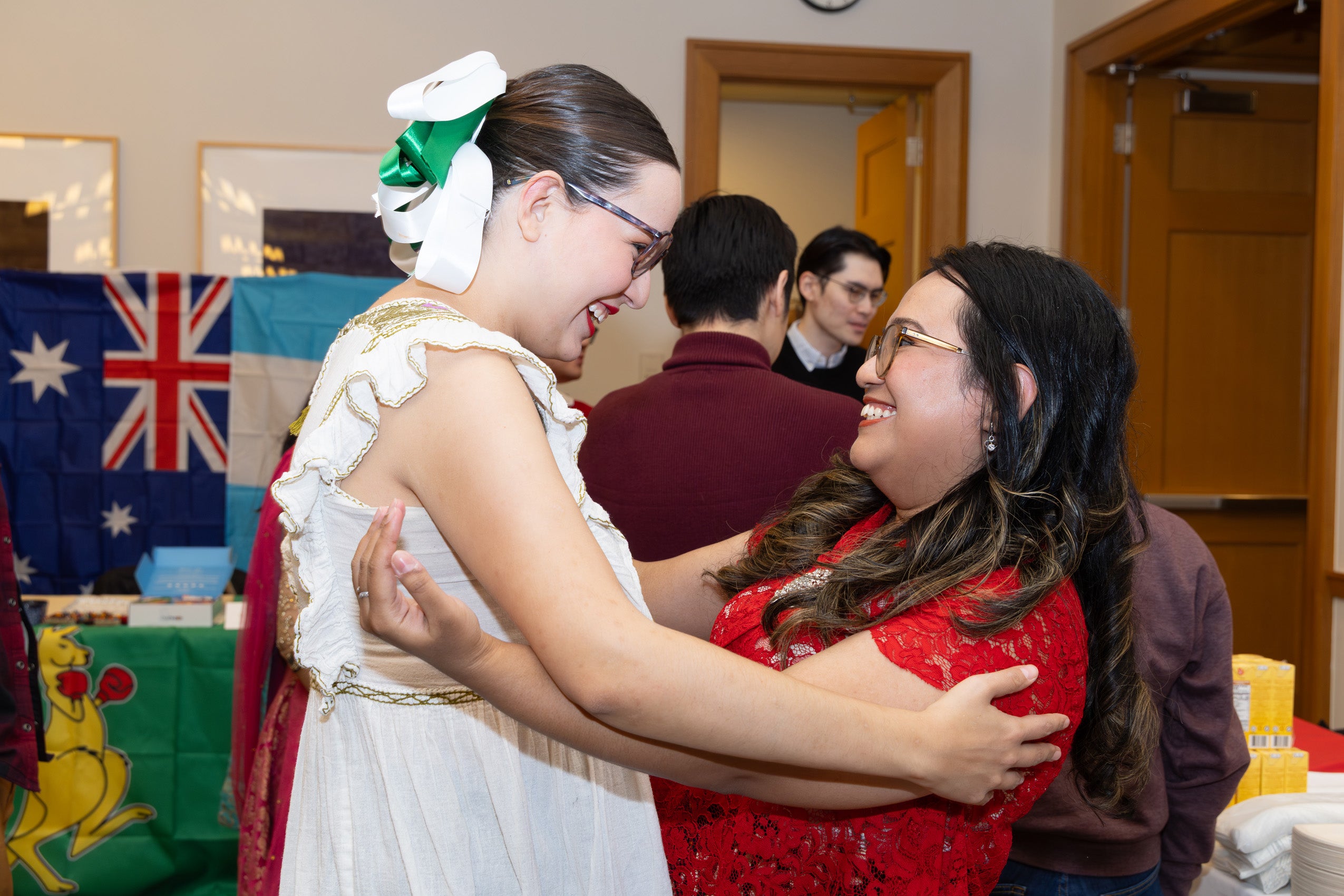 Two students great each other at an event.