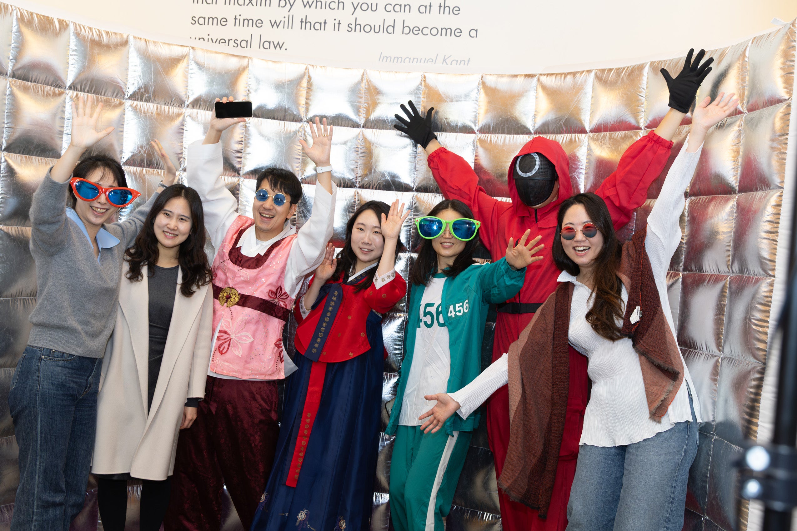 A group of students gather for a photo booth photo.