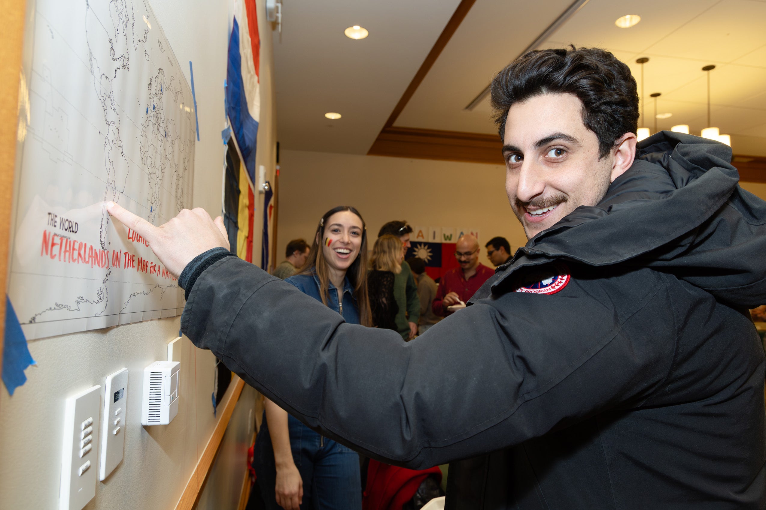 A student points to a location on a map.