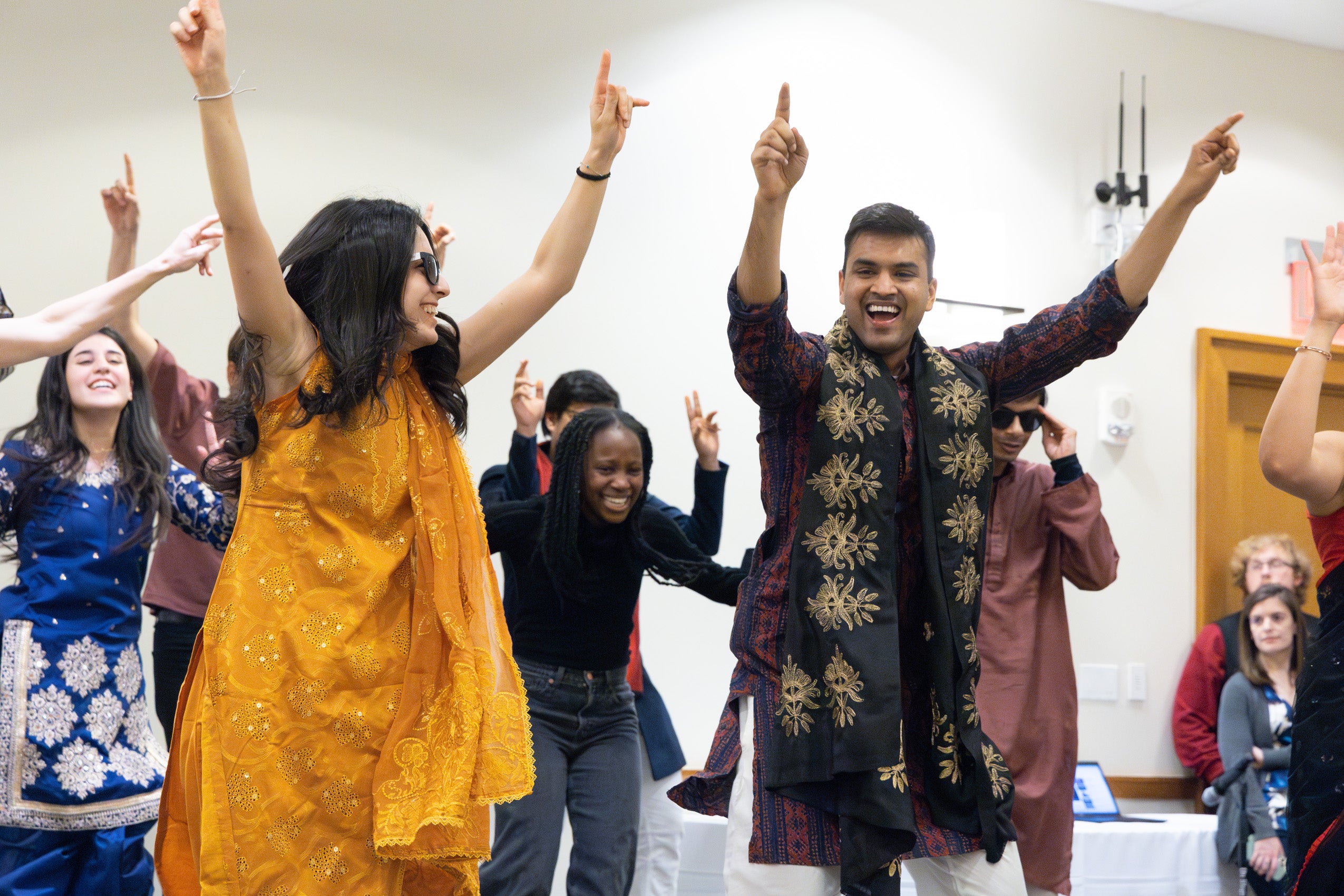 Students learn a dance on stage.