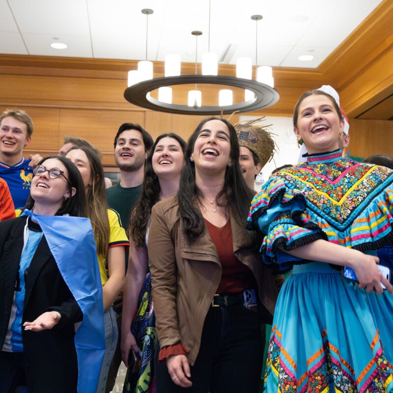 A group of students enjoy a performance.