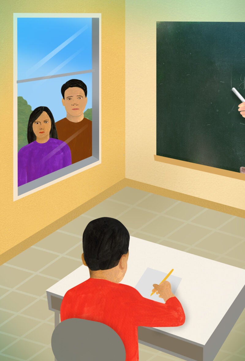 Illustration showing a classroom with parents looking through a window as a young boy is writing at his desk.