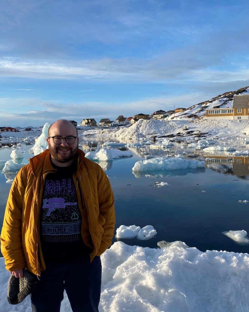 Shay Elbaum standing in front of a snowy lake.