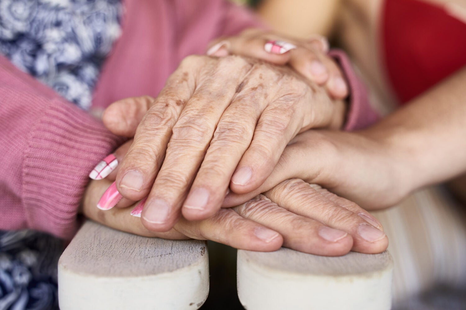 Hands of a young person and an older person.