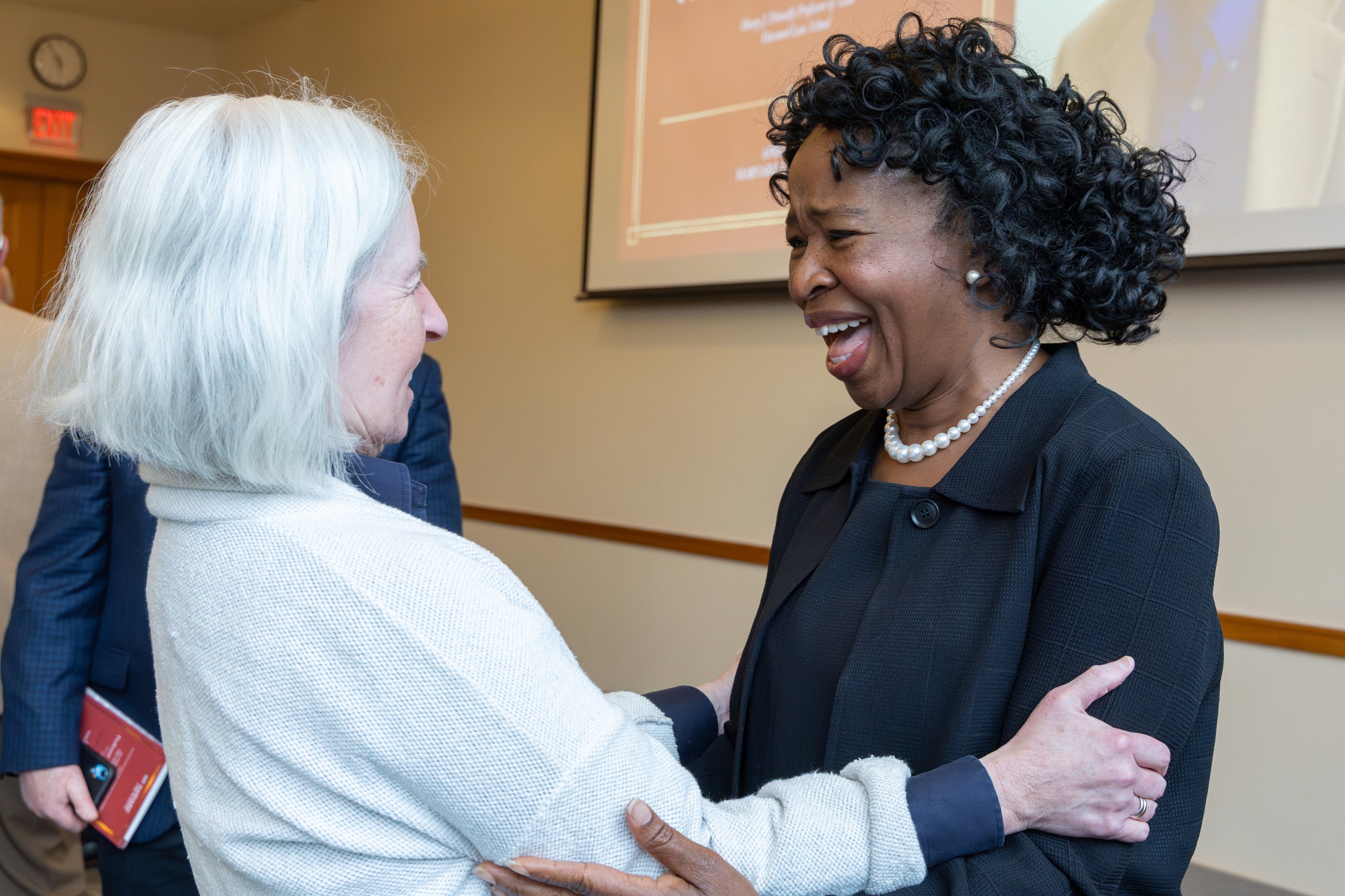 Martha Minow greets Ruth Okediji.