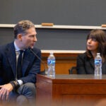 Man and woman speaking at panel.