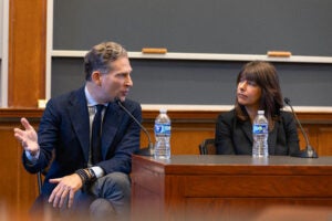 Man and woman speaking at panel.