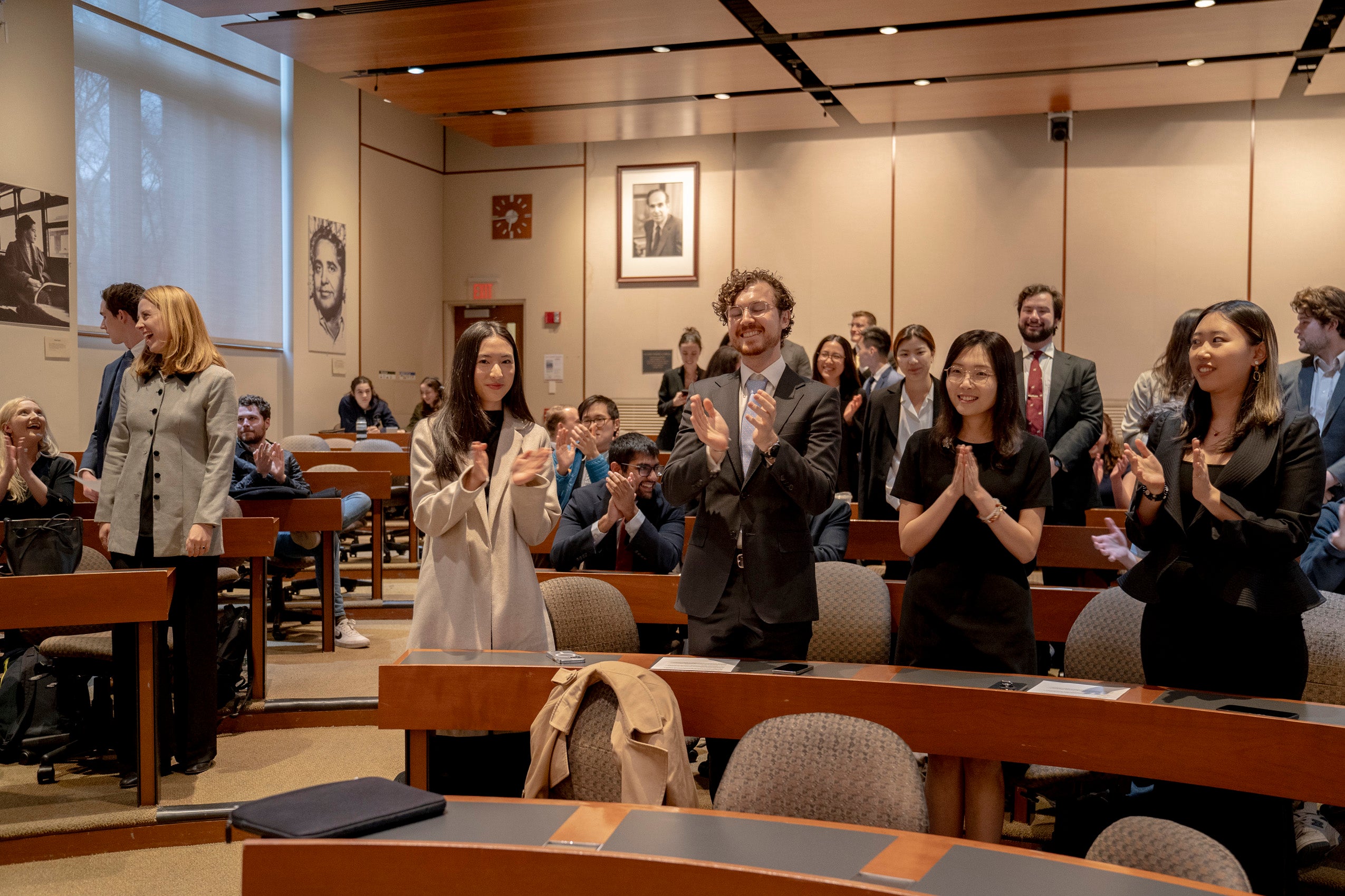 Attendees at the closing Williston Competition event ceremonies applaud.
