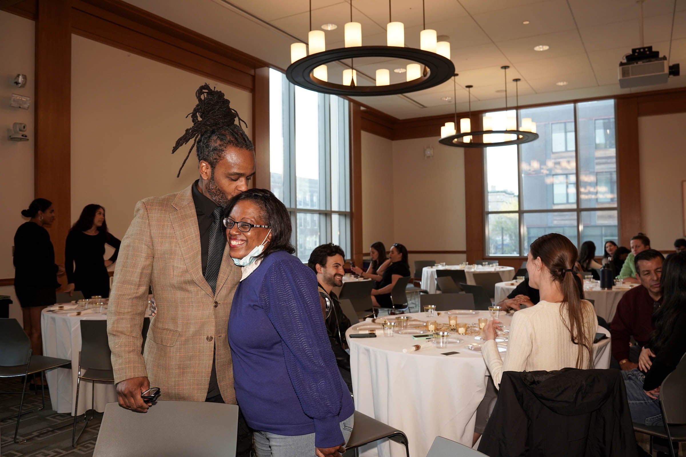 Awards host embracing an awardee.