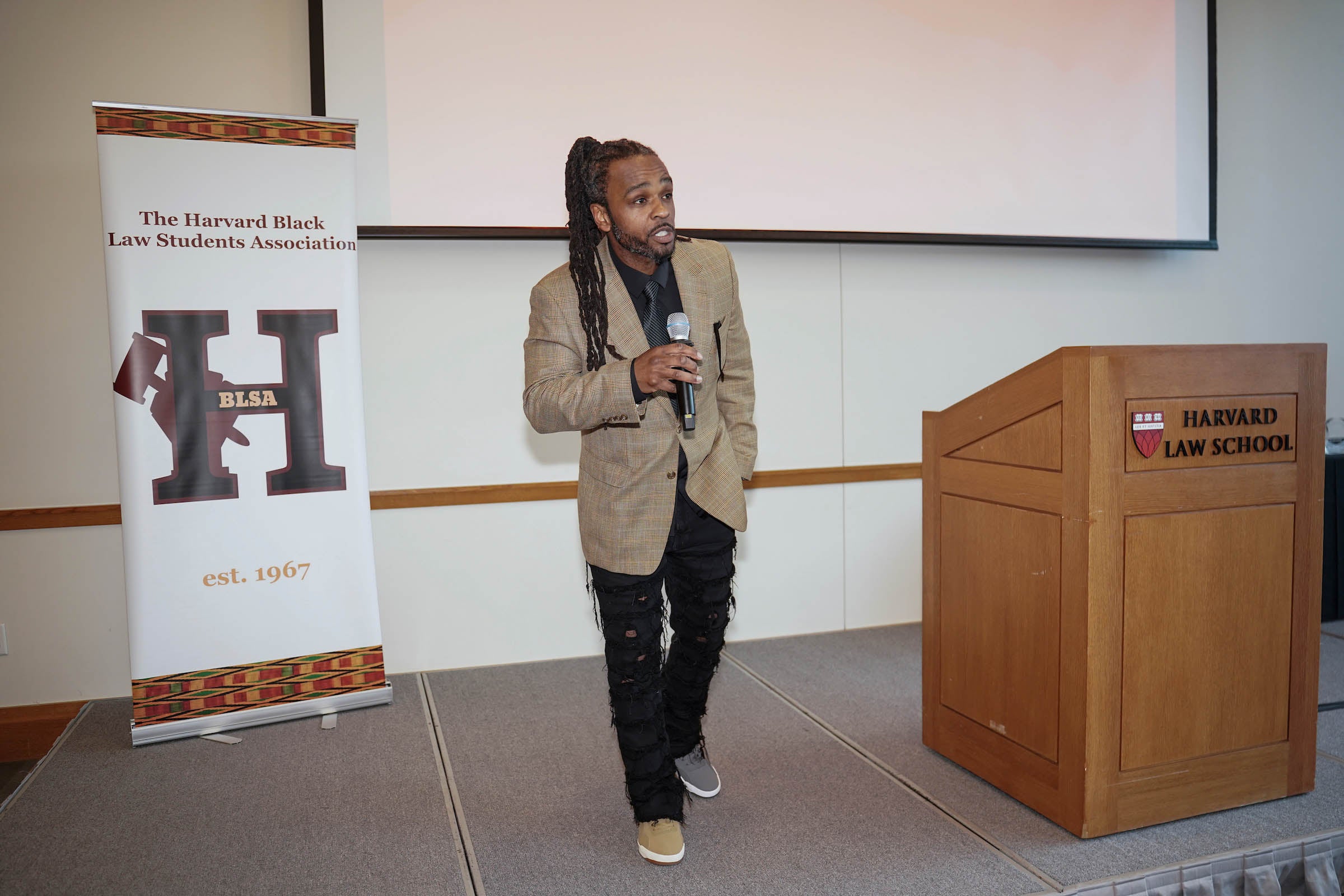 Awards host Brione Merchant delivers remarks.