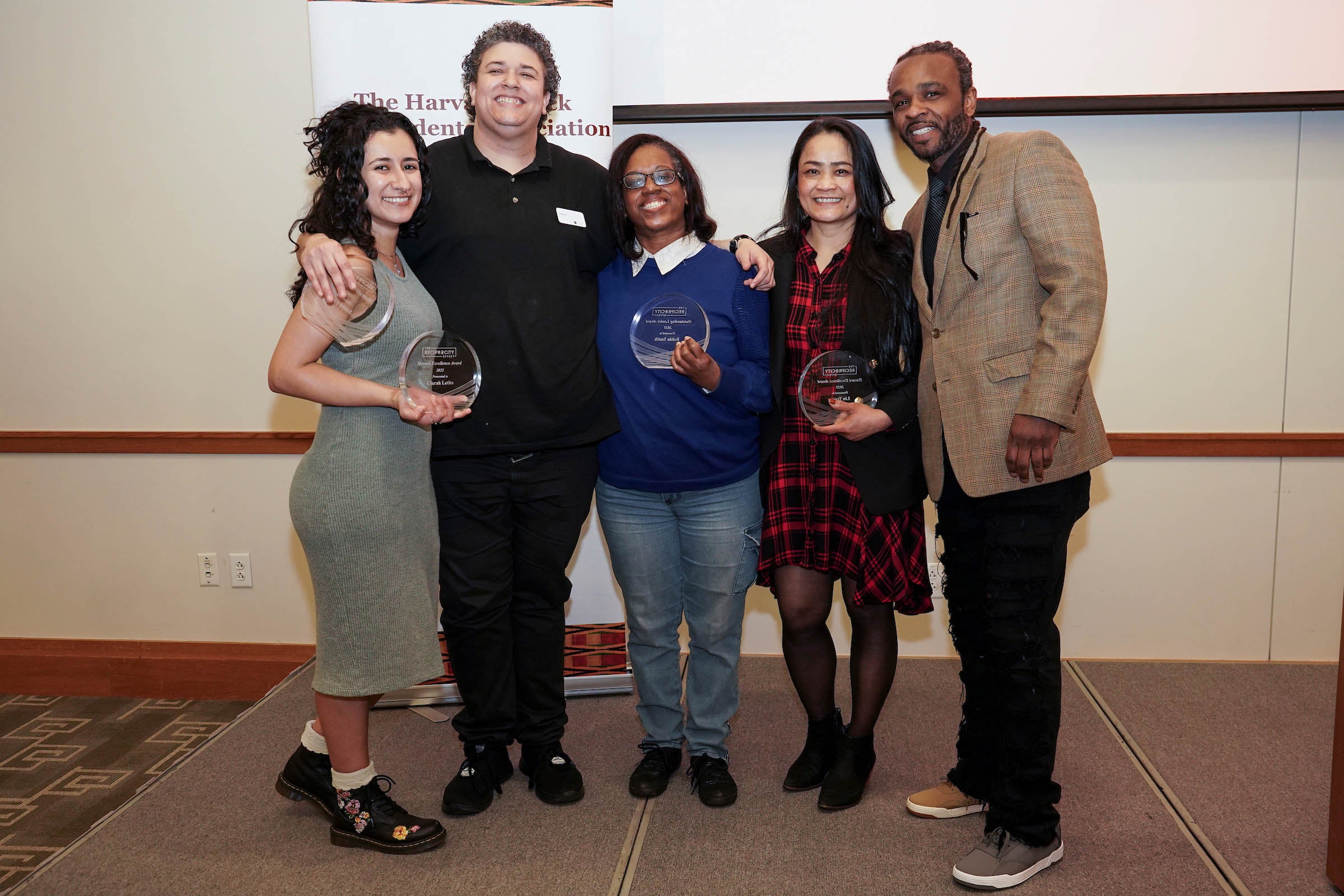 Four awardees pose with the awards host.