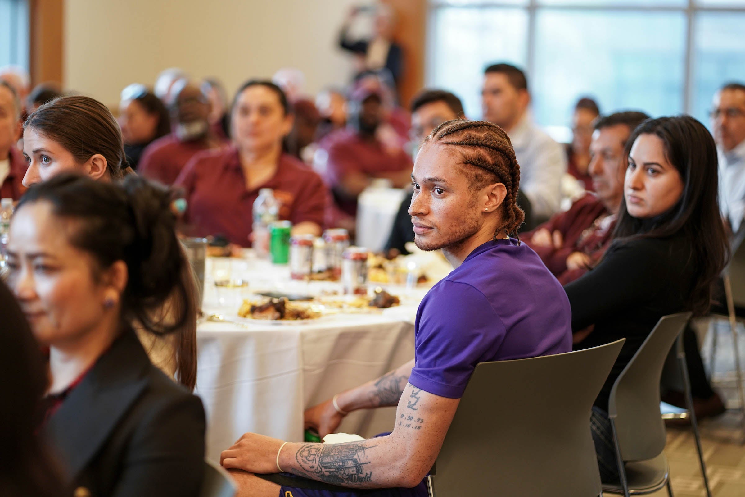 Audience members listen intently.