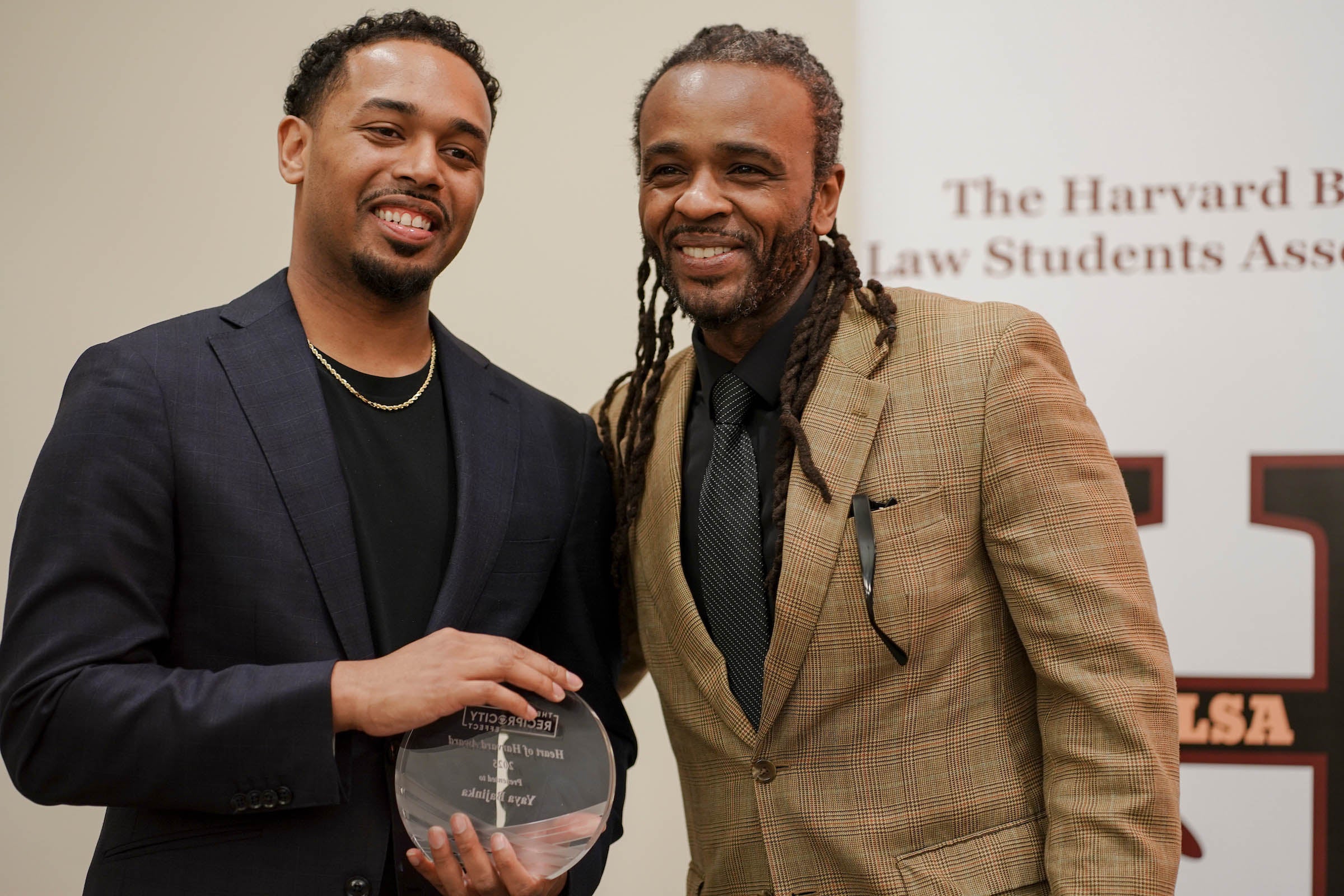 Rehan Staton poses onstage with Brione Merchant.