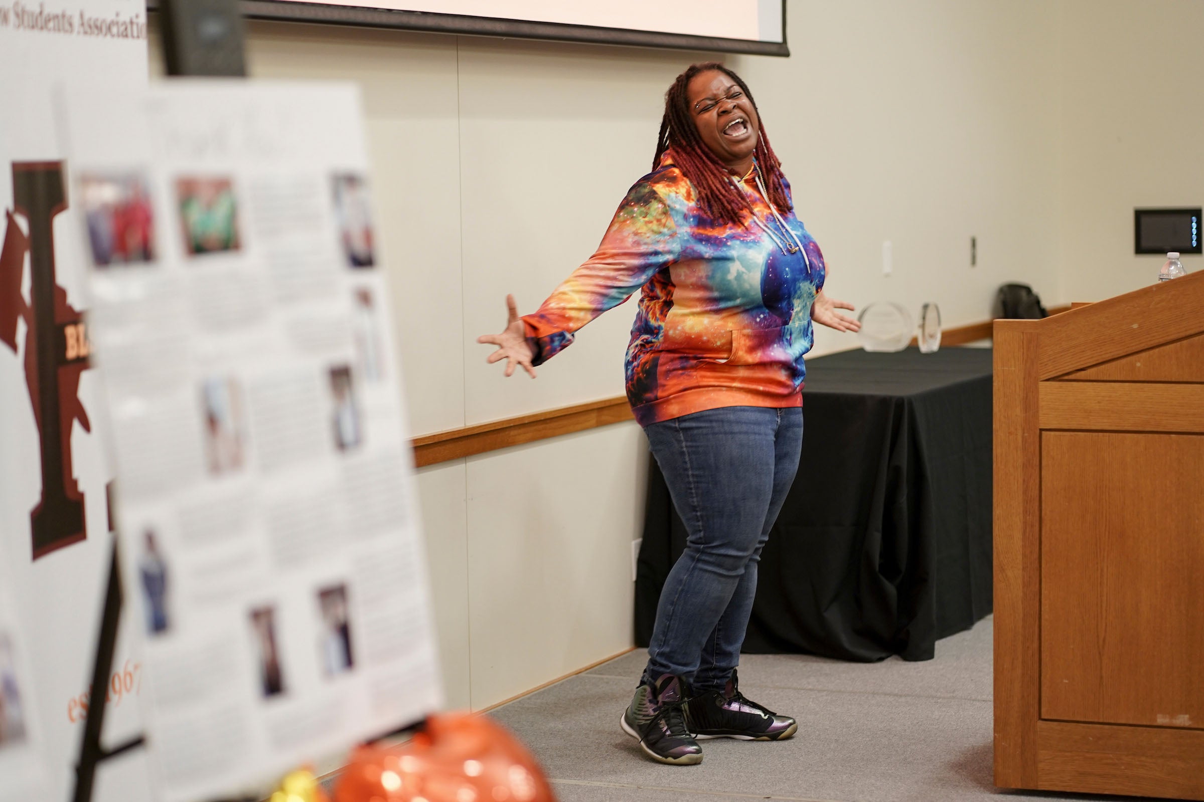 Spoken word poet Tru Kwene performs animatedly.