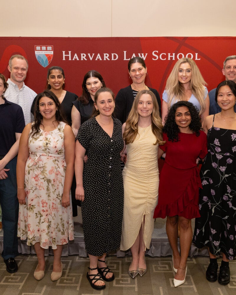 Y-Lab graduating students smile in front a HLS banner