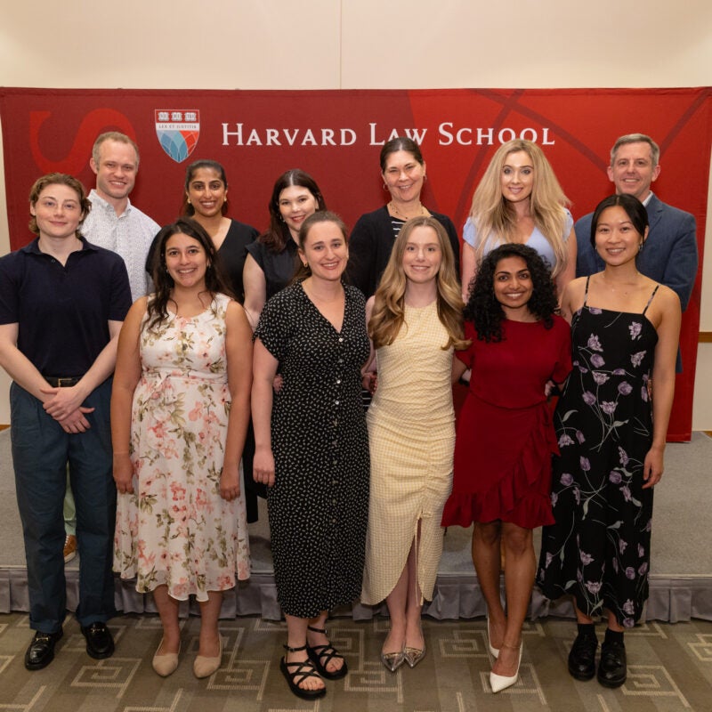 Y-Lab graduating students smile in front a HLS banner