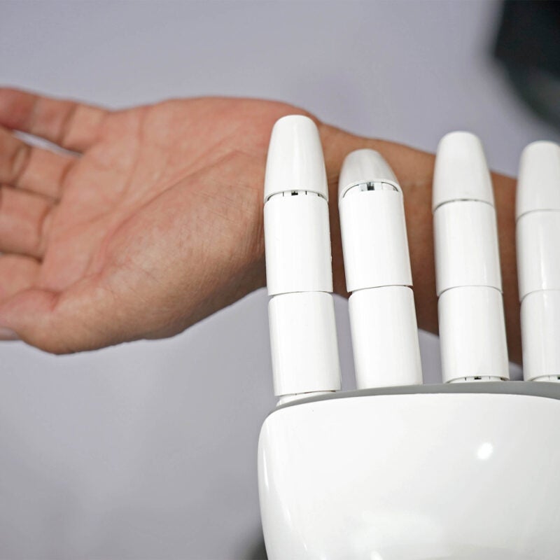 Robot checking human pulse.