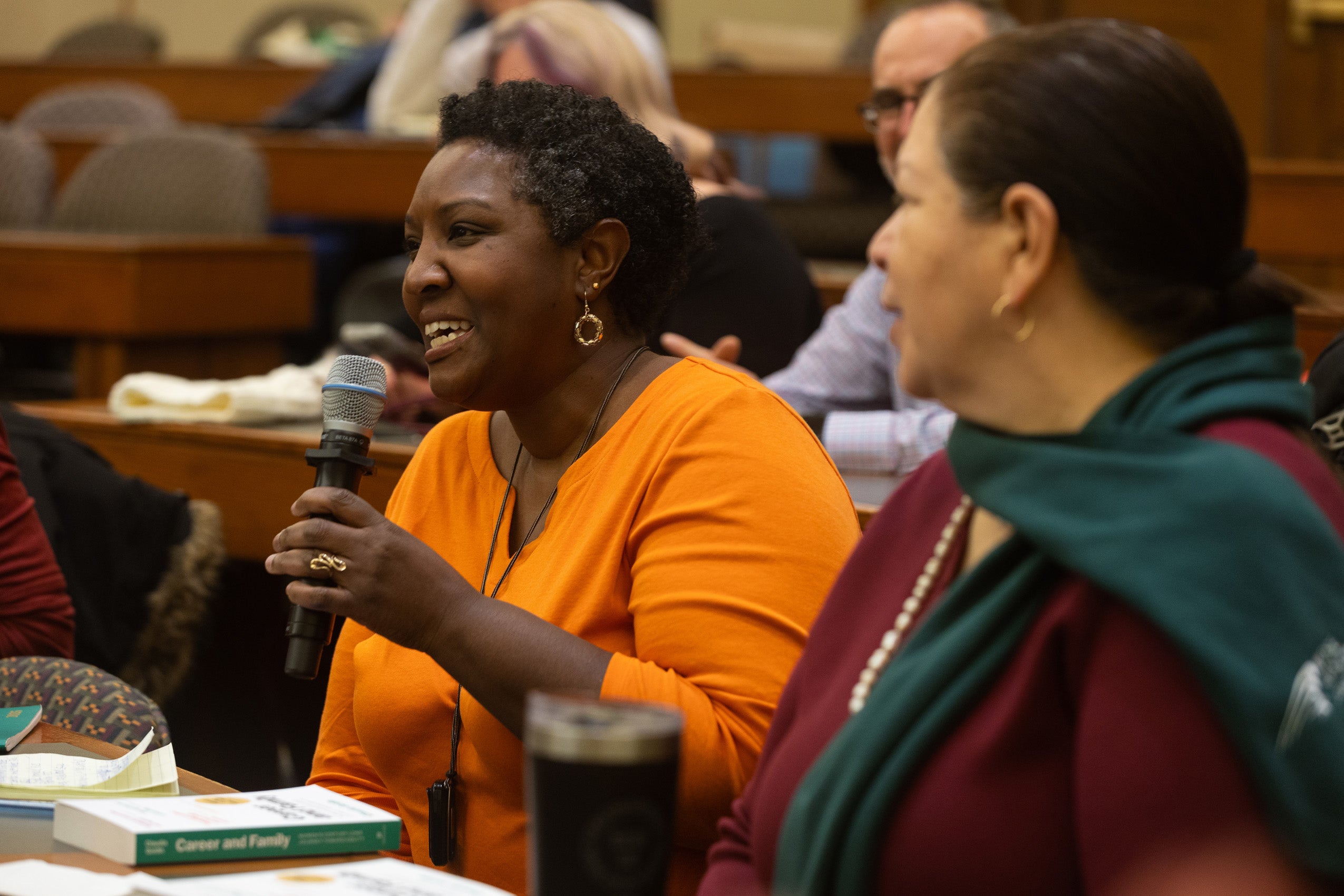 A woman asks a question from the audience.