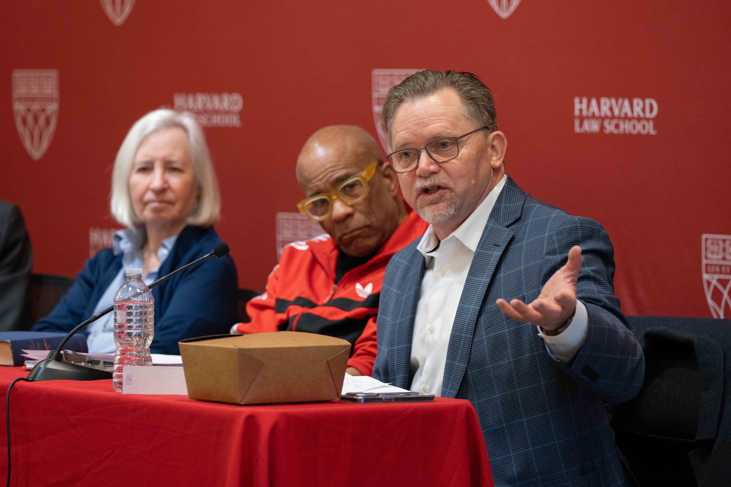 A man speaks on a panel.