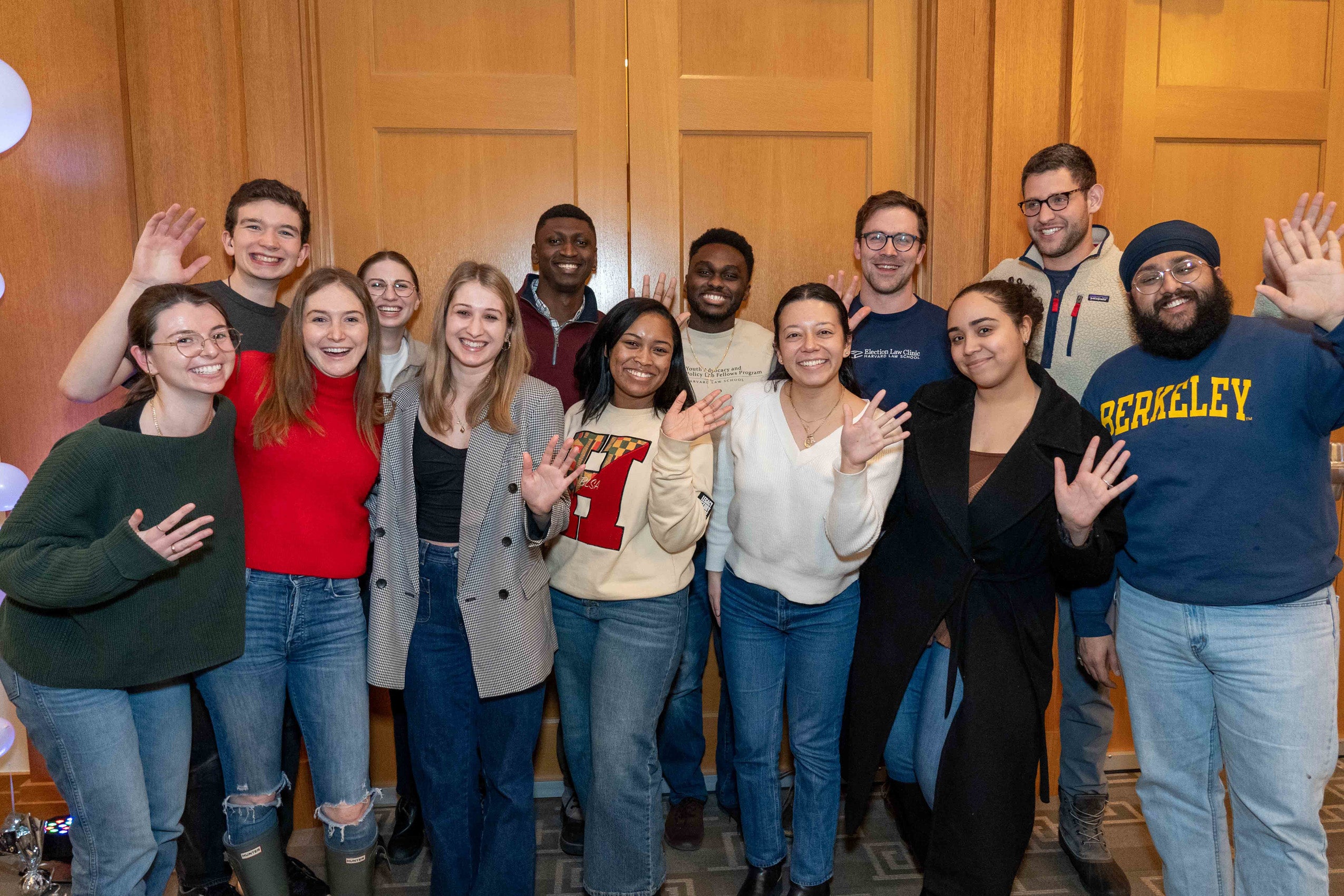A group of students waving.