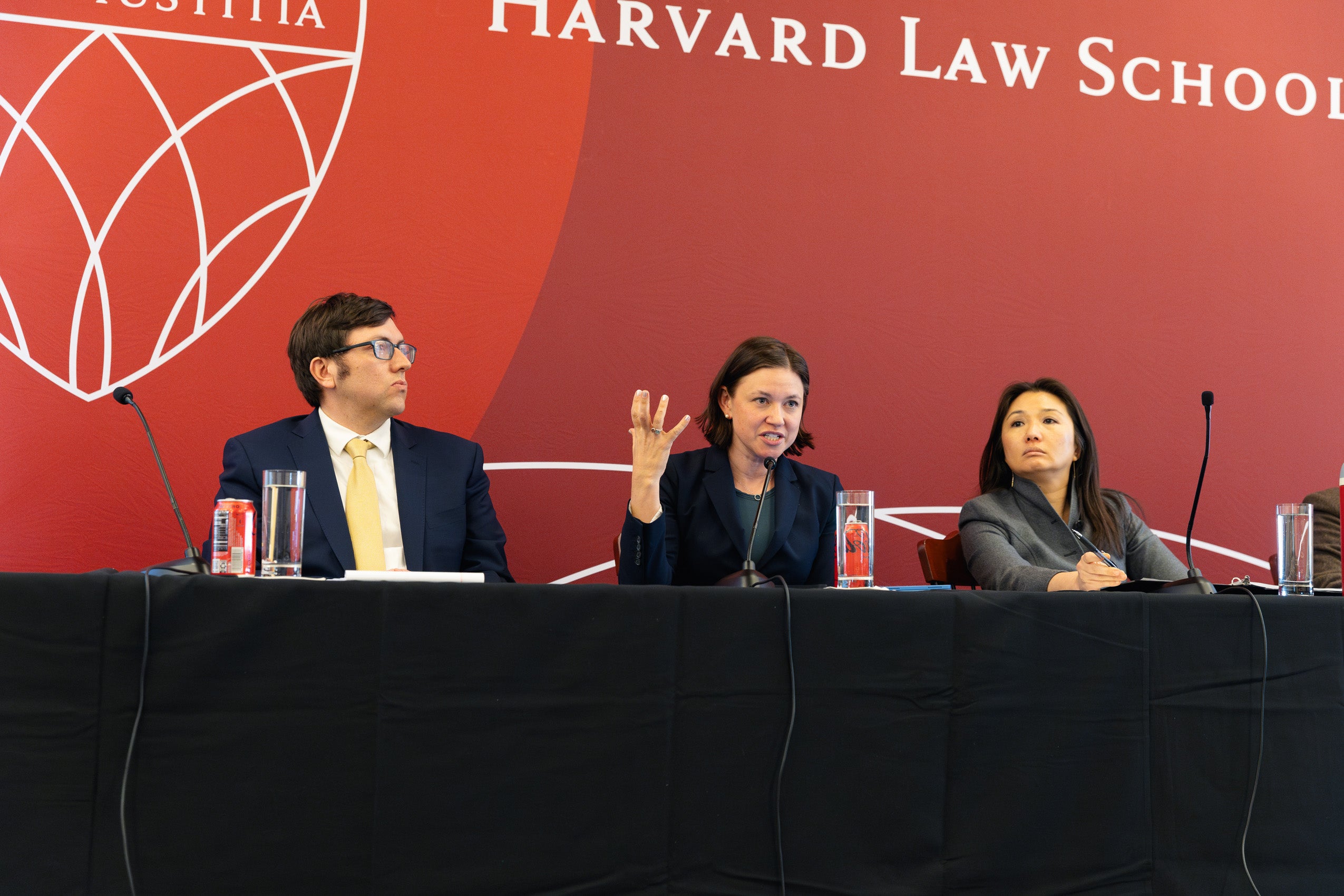 Three people speaking on a panel.