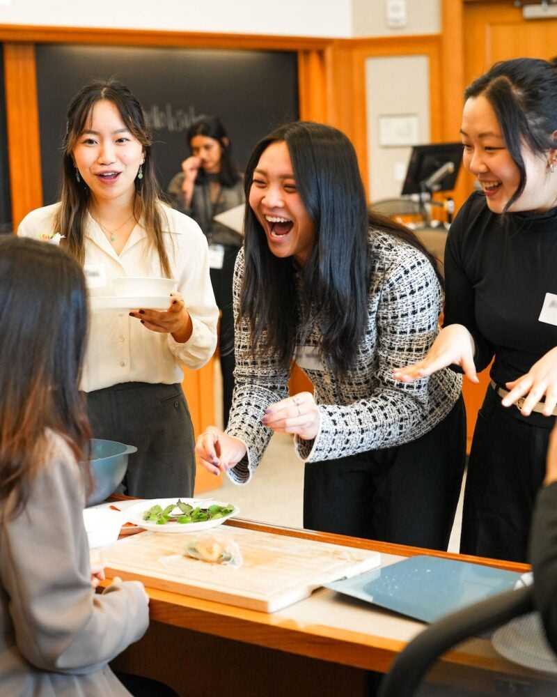 Three students share a fun moment at an event.