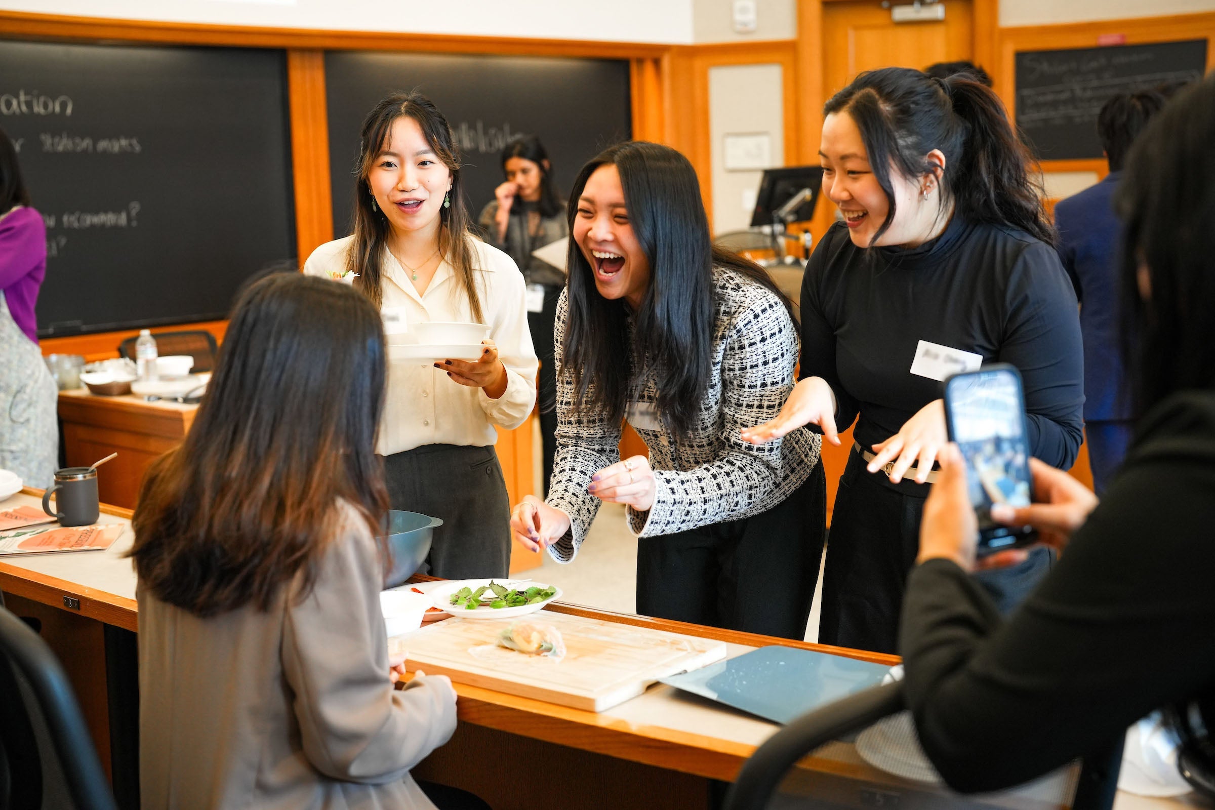 Three students share a fun moment at an event.