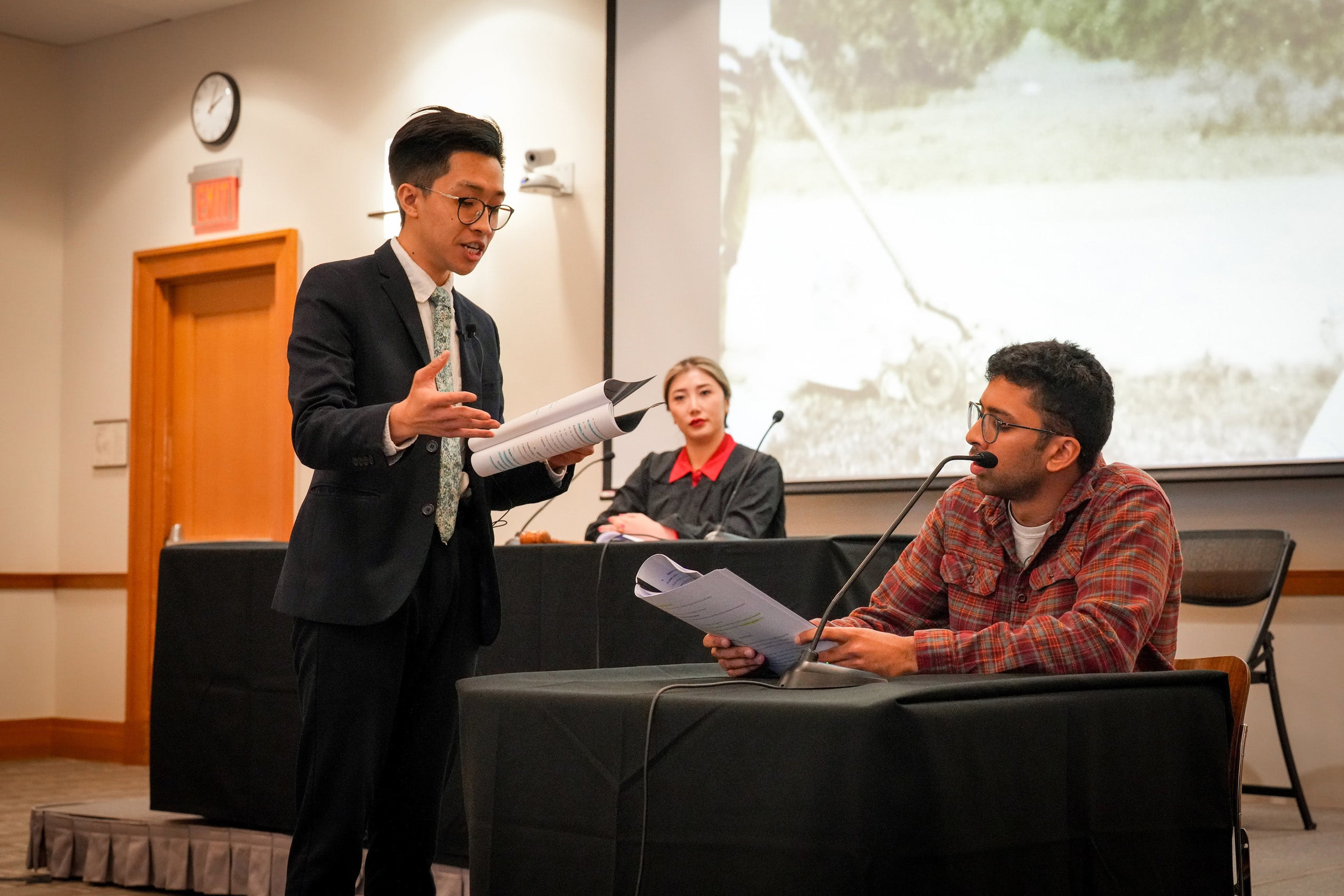 Two men read from a script as a 