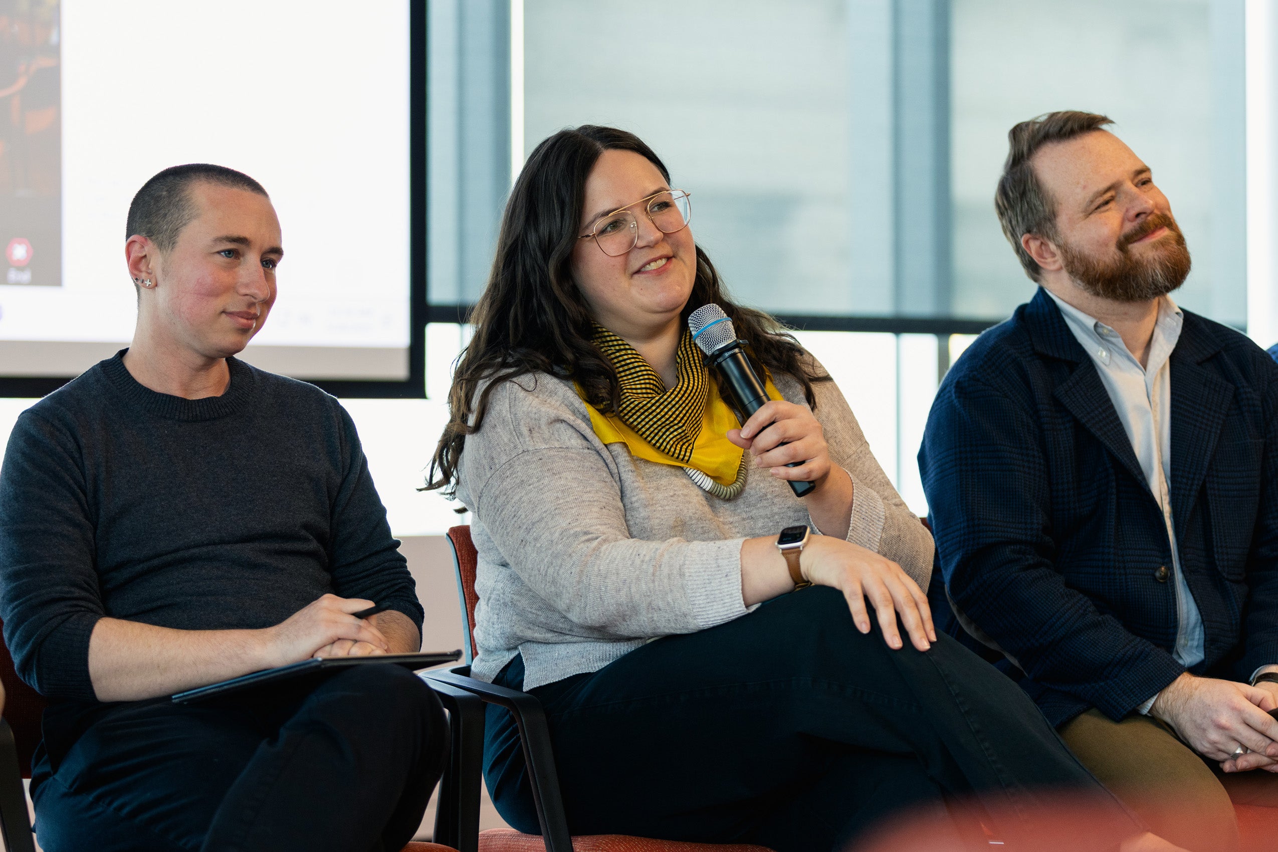 Panelists speak at an event.