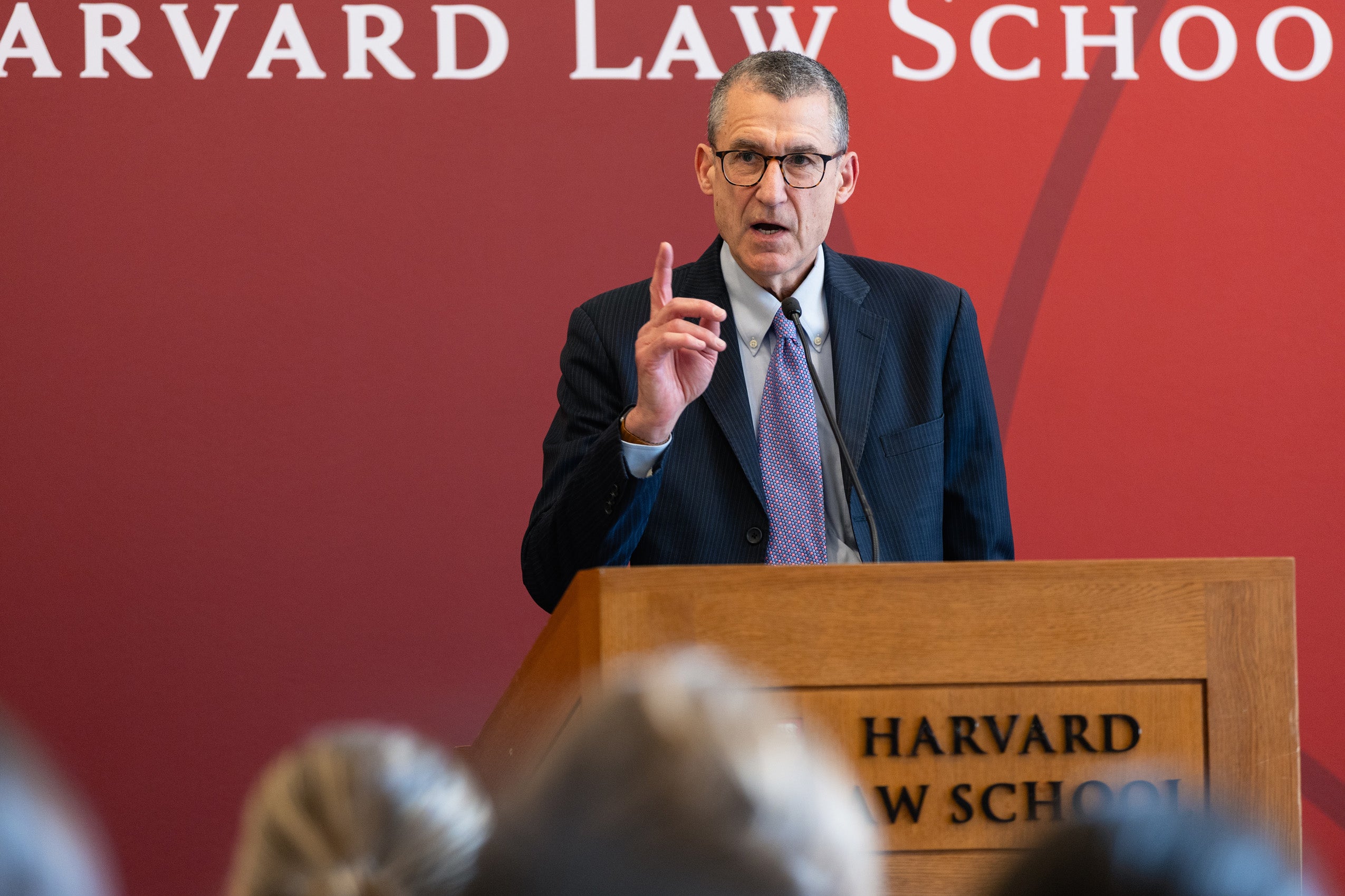 William Rubenstein speaking at a podium.
