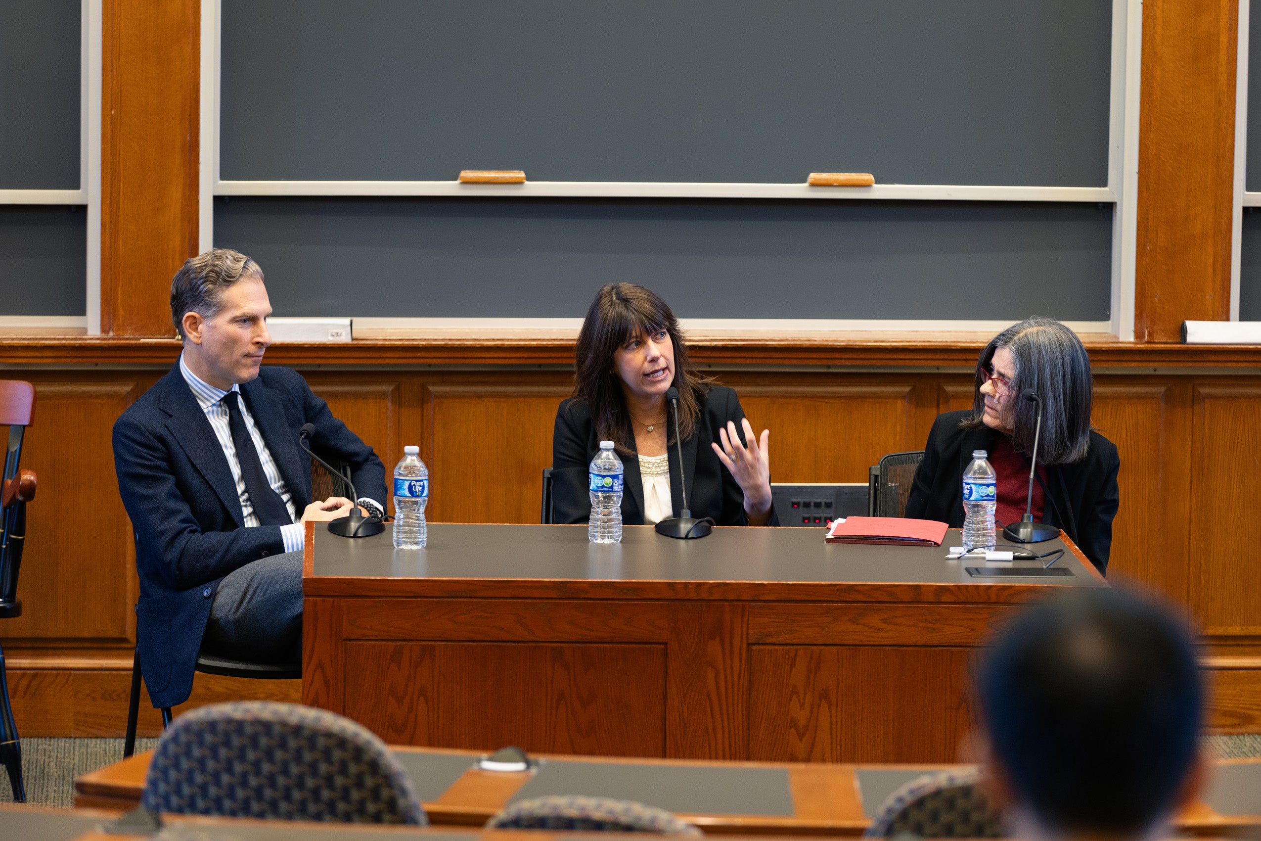 Noah Feldman, Elizabeth Prelogar, and Lucie White speak at an event in a classroom.