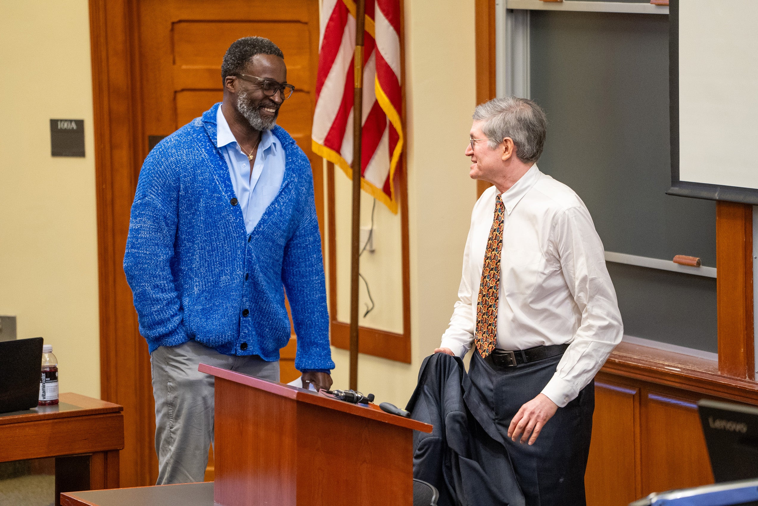 Michael Klarman speaks with a man at the front of classroom.