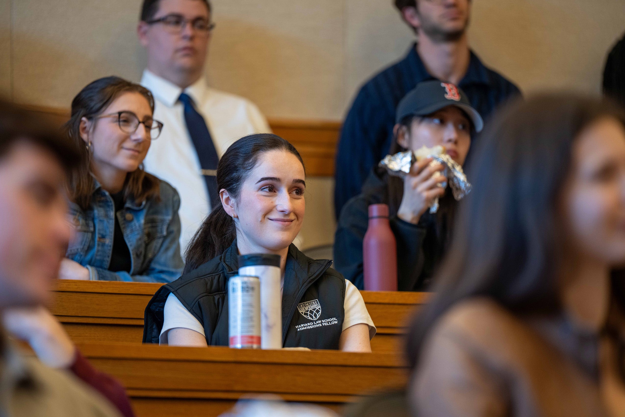 A student listens from a desk in a classroom.