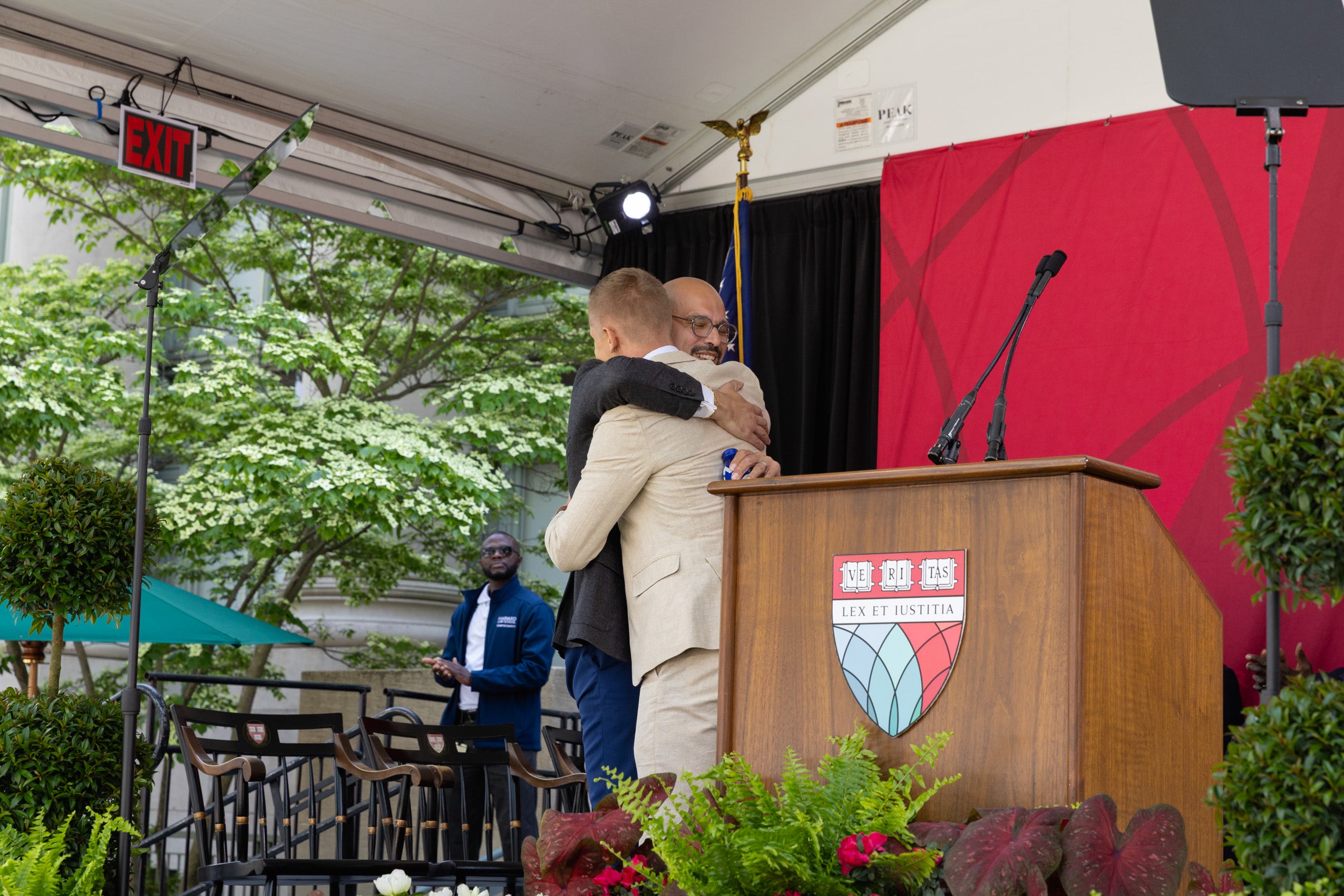 Two men embrace on stage