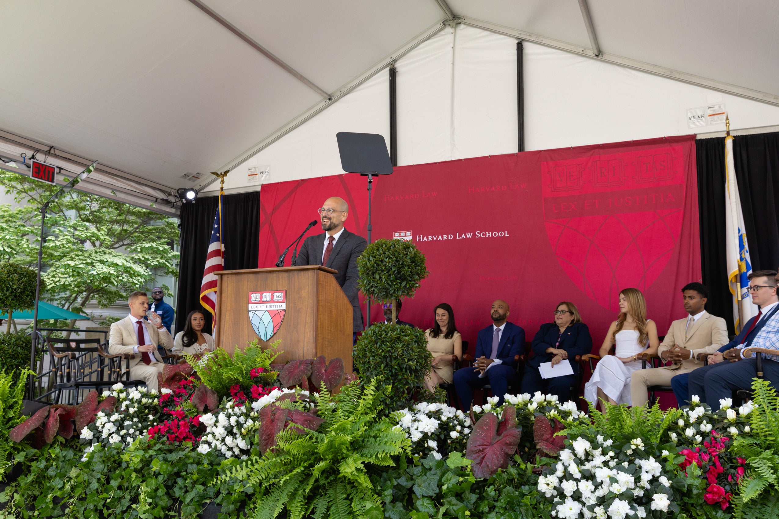 A man standing and speaking at a podium