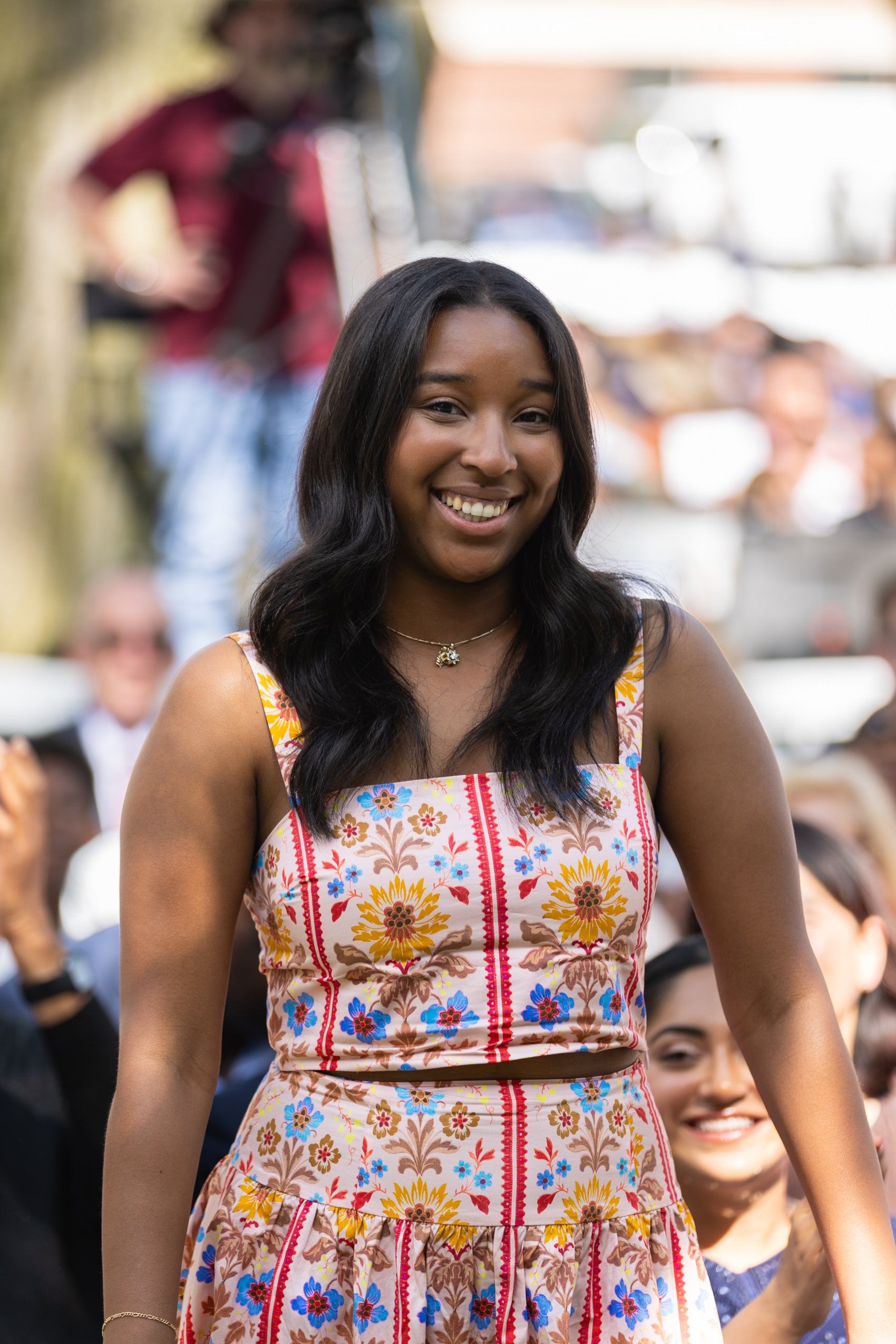 A woman standing and smiling