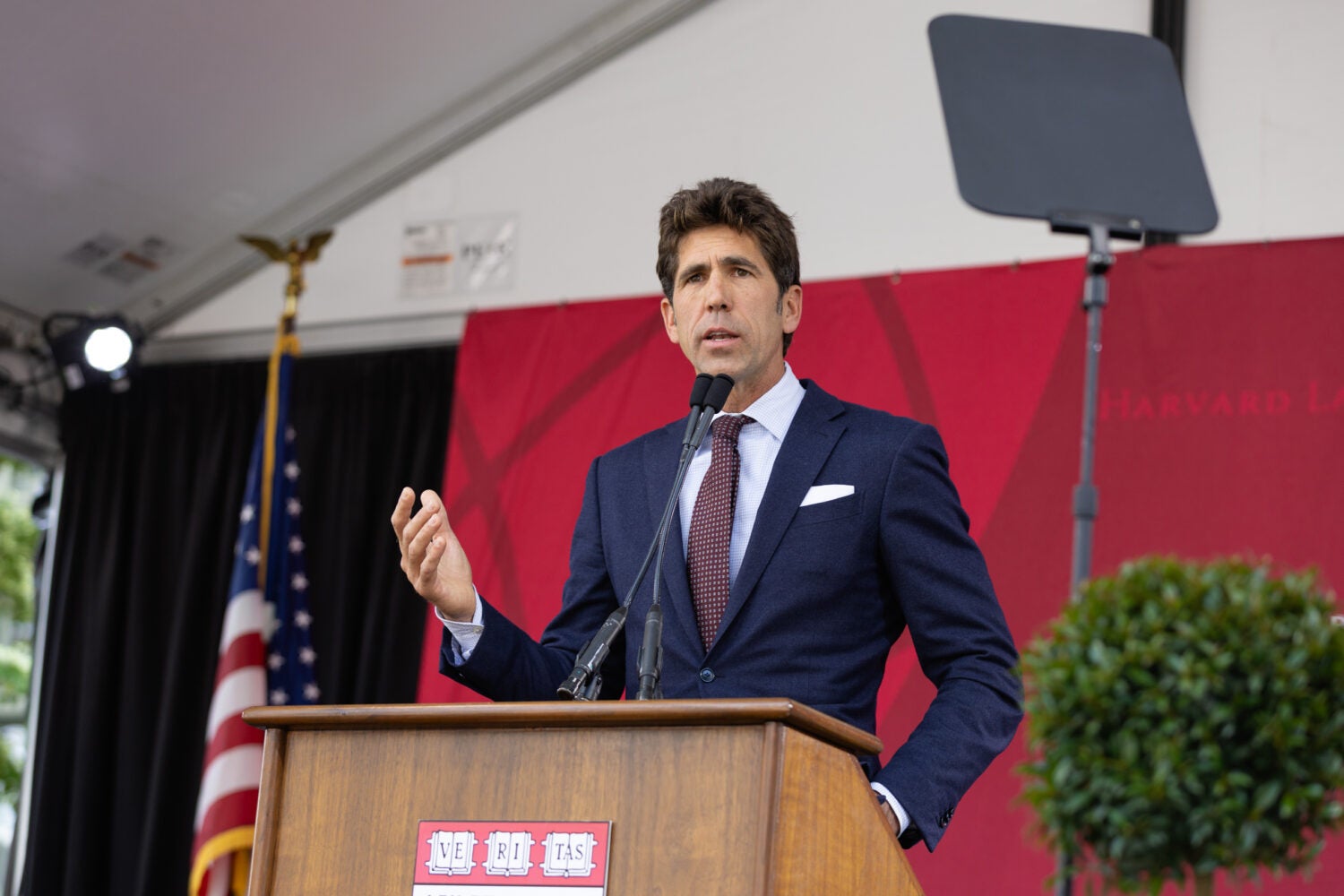 A man standing and speaking at a podium