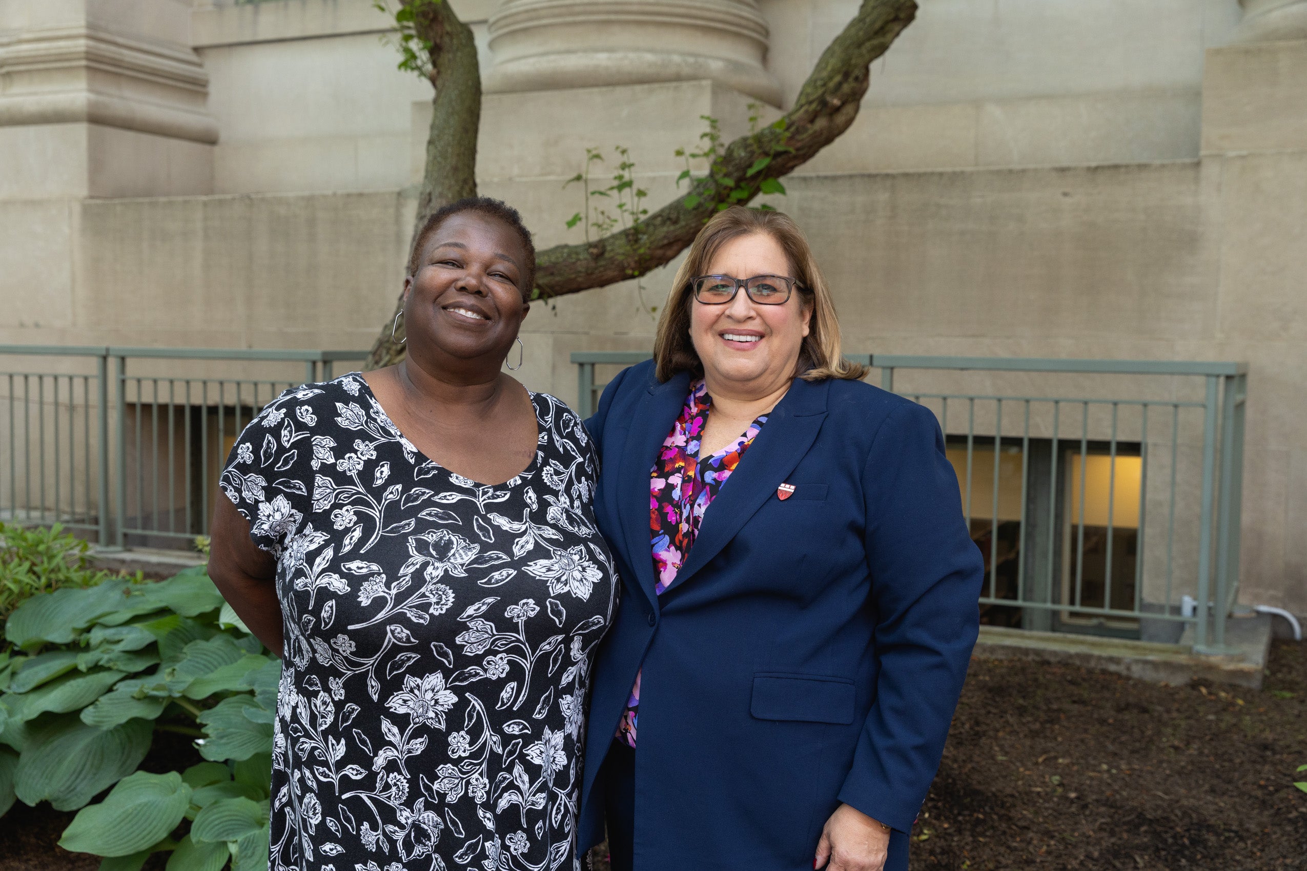 Two women standing together and smiling
