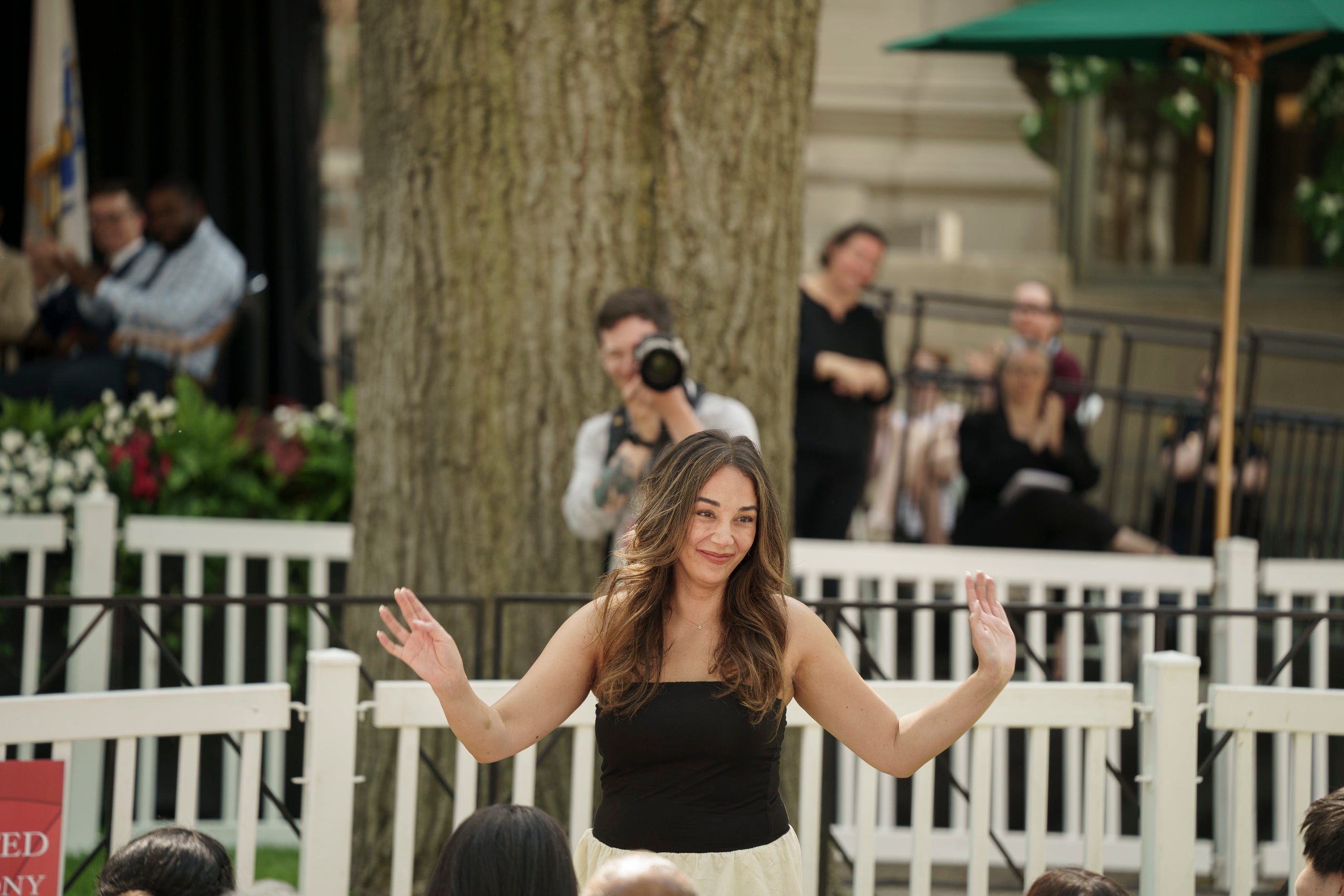 A woman waving to the audience