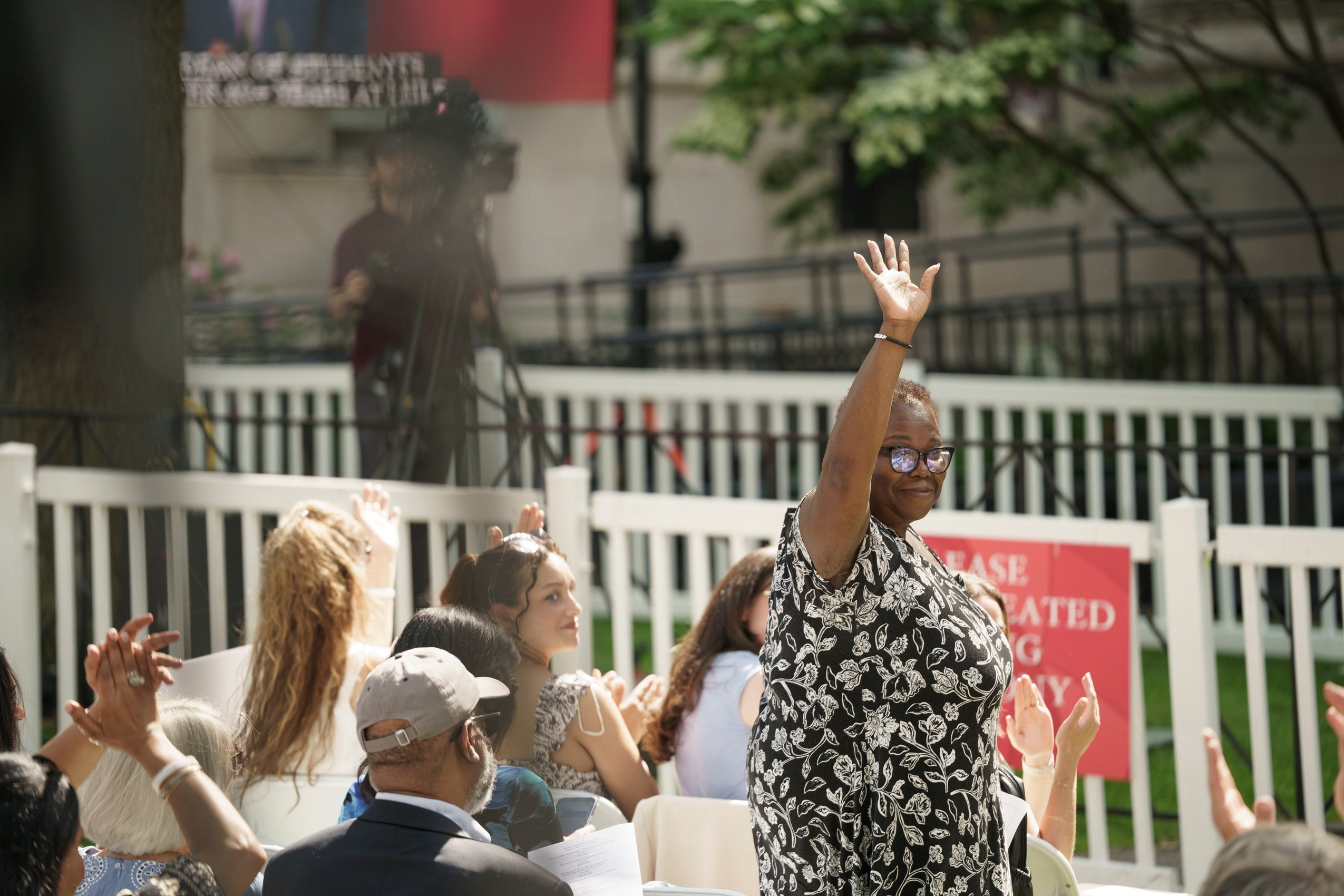 A woman waving to the audience